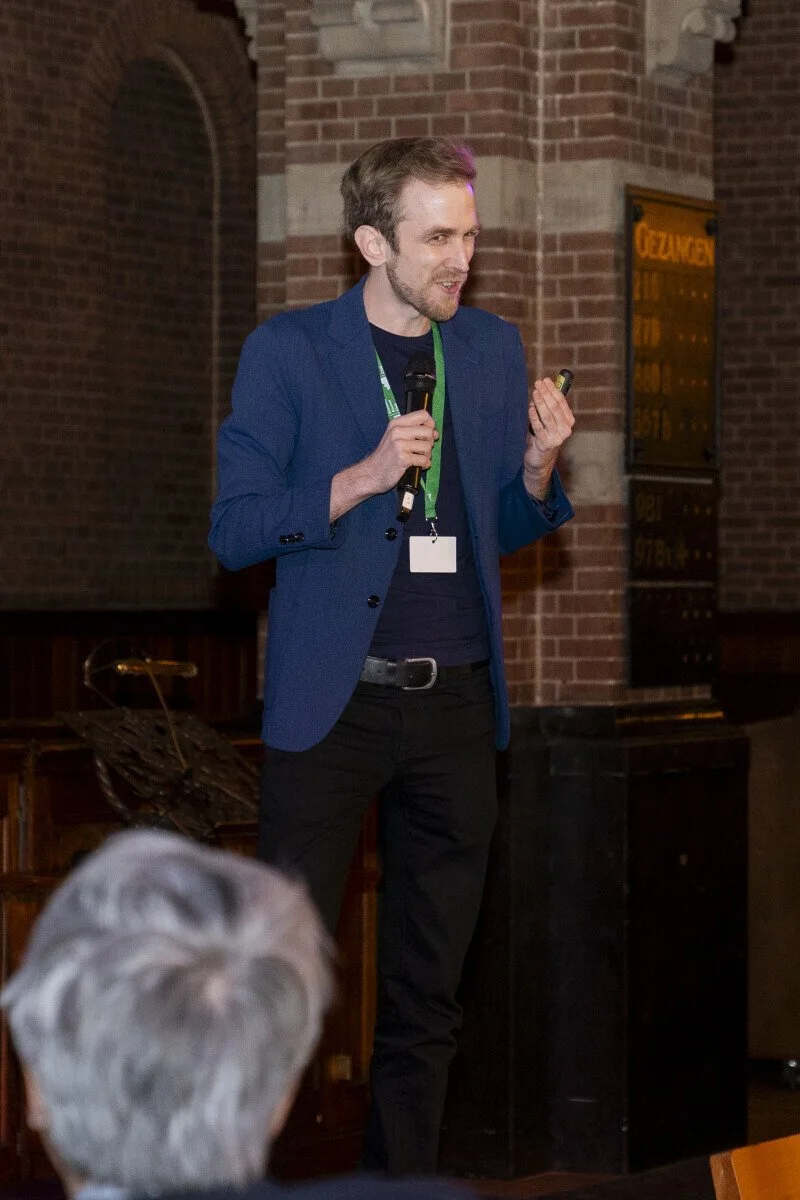 Matt Hrusc, founder of LifeVersity, speaking with a microphone