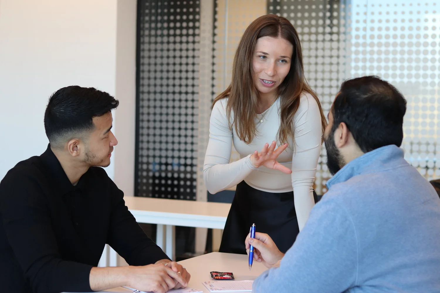 A LifeVersity trainer in conversation with two professionals