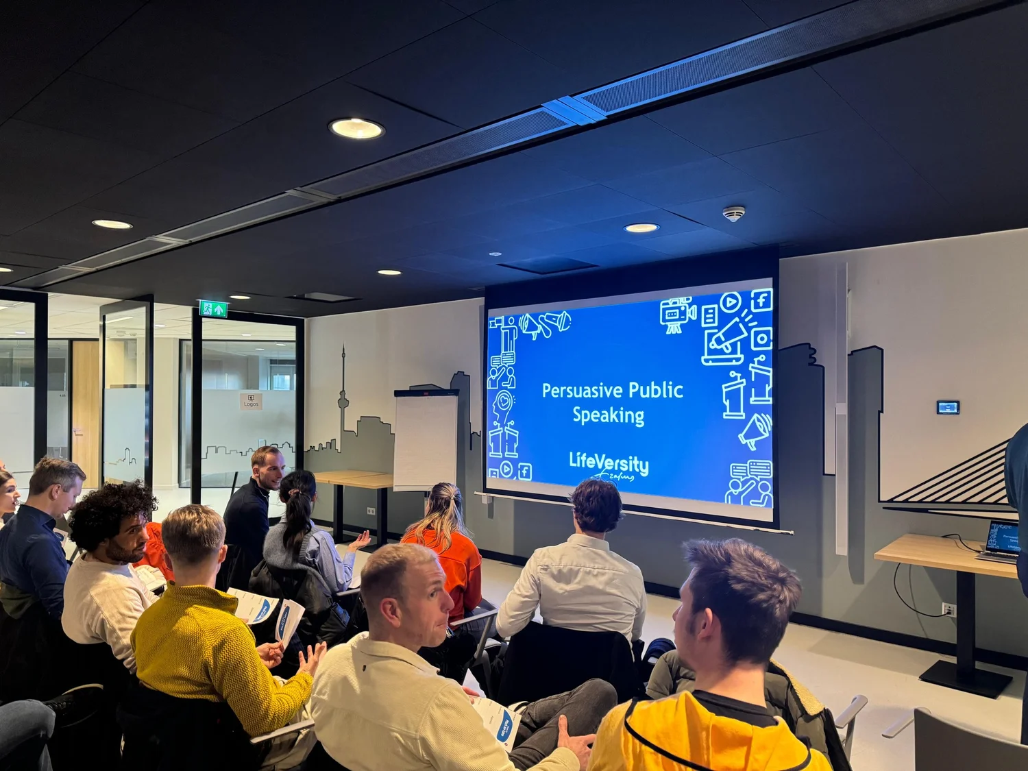 A trainer leading a Persuasive Public Speaking session for a company