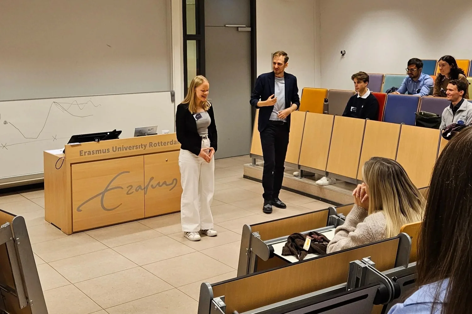 Two trainers at the front of a lecture hall