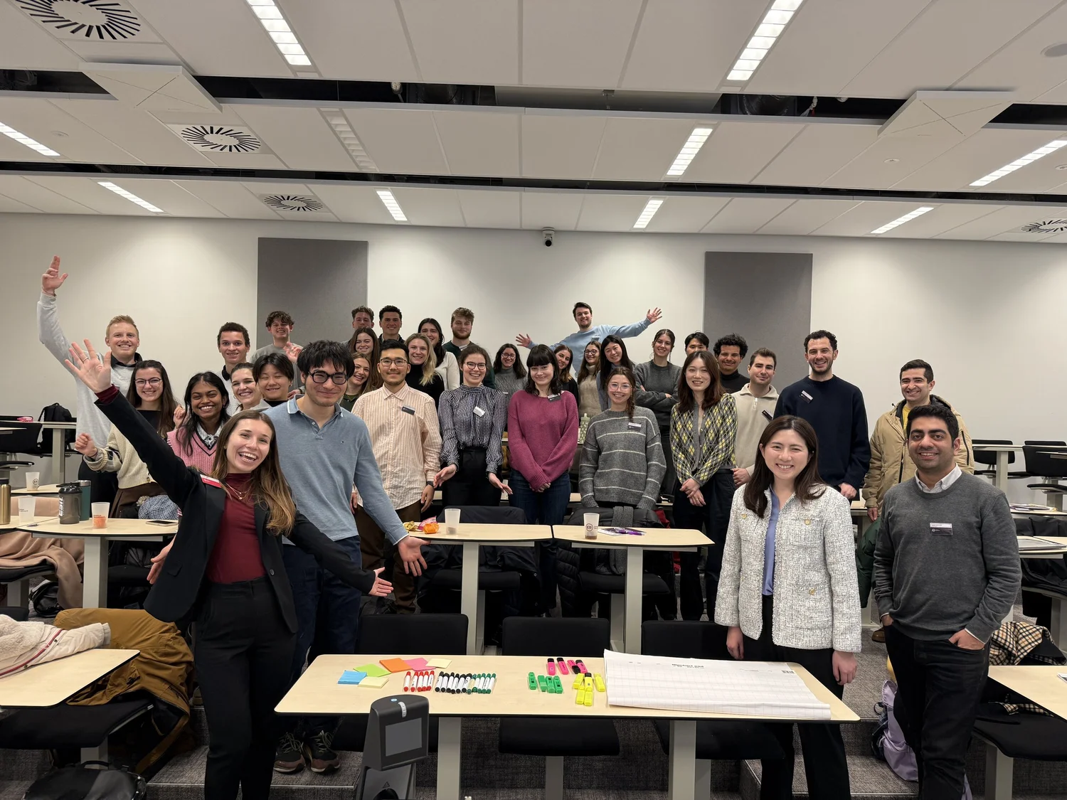 Workshop participants cheering together in a classroom