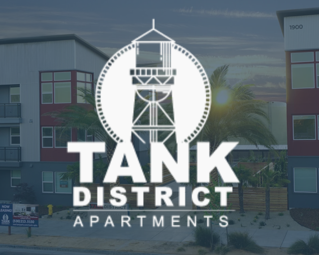Logo for Tank District Apartments with an illustration of a lighthouse inside a circle above the text.