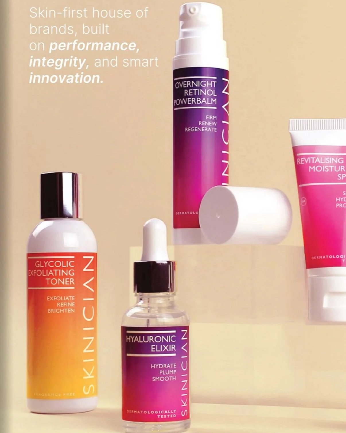 Skincare products arranged on a surface with a beige background. From left to right: a white bottle with a silver cap labeled 'Glycolic Exfoliating Toner,' a small bottle with a dropper labeled 'Hyaluronic Elixir,' a purple and pink bottle labeled 'Overnight Retinol Power Balm,' and a pink tube labeled 'Revitalising Moisturising SPF.'
