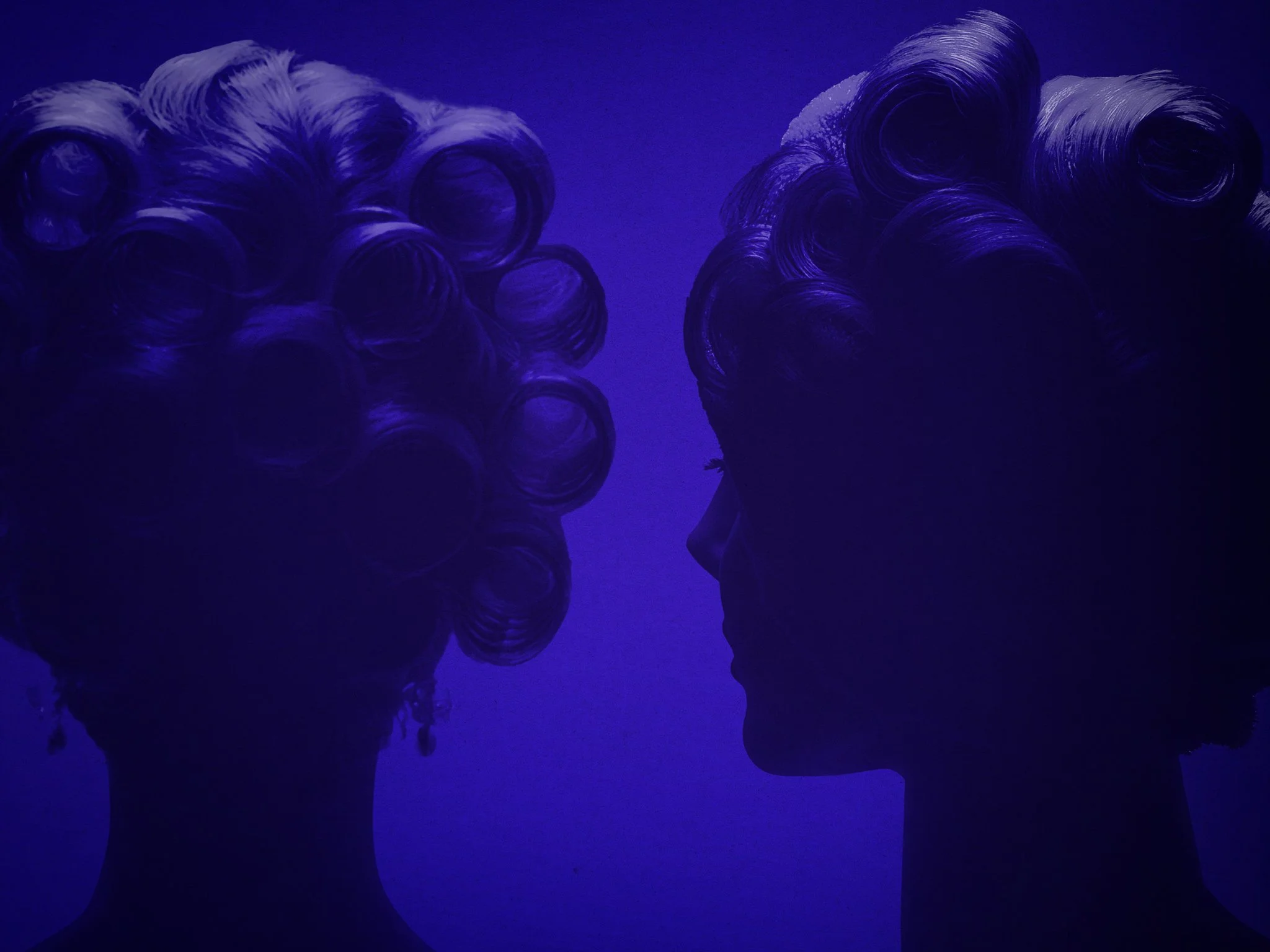 Silhouette of a woman with styled hair and earrings, illuminated by blue and purple lighting, facing a mirror with her back to the viewer.