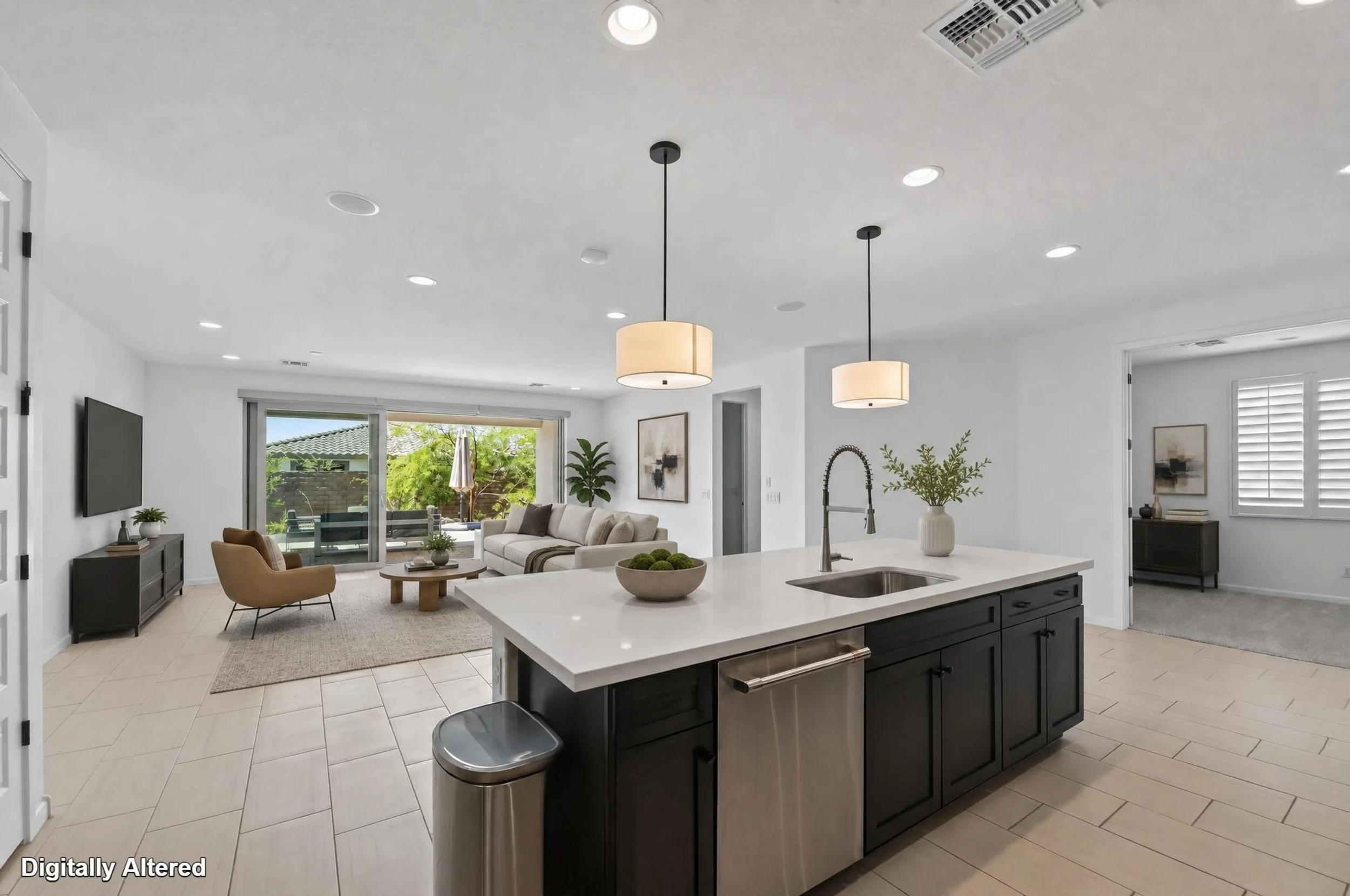 Virtual staging of living room and den looking out at the backyard through large sliding doors. 