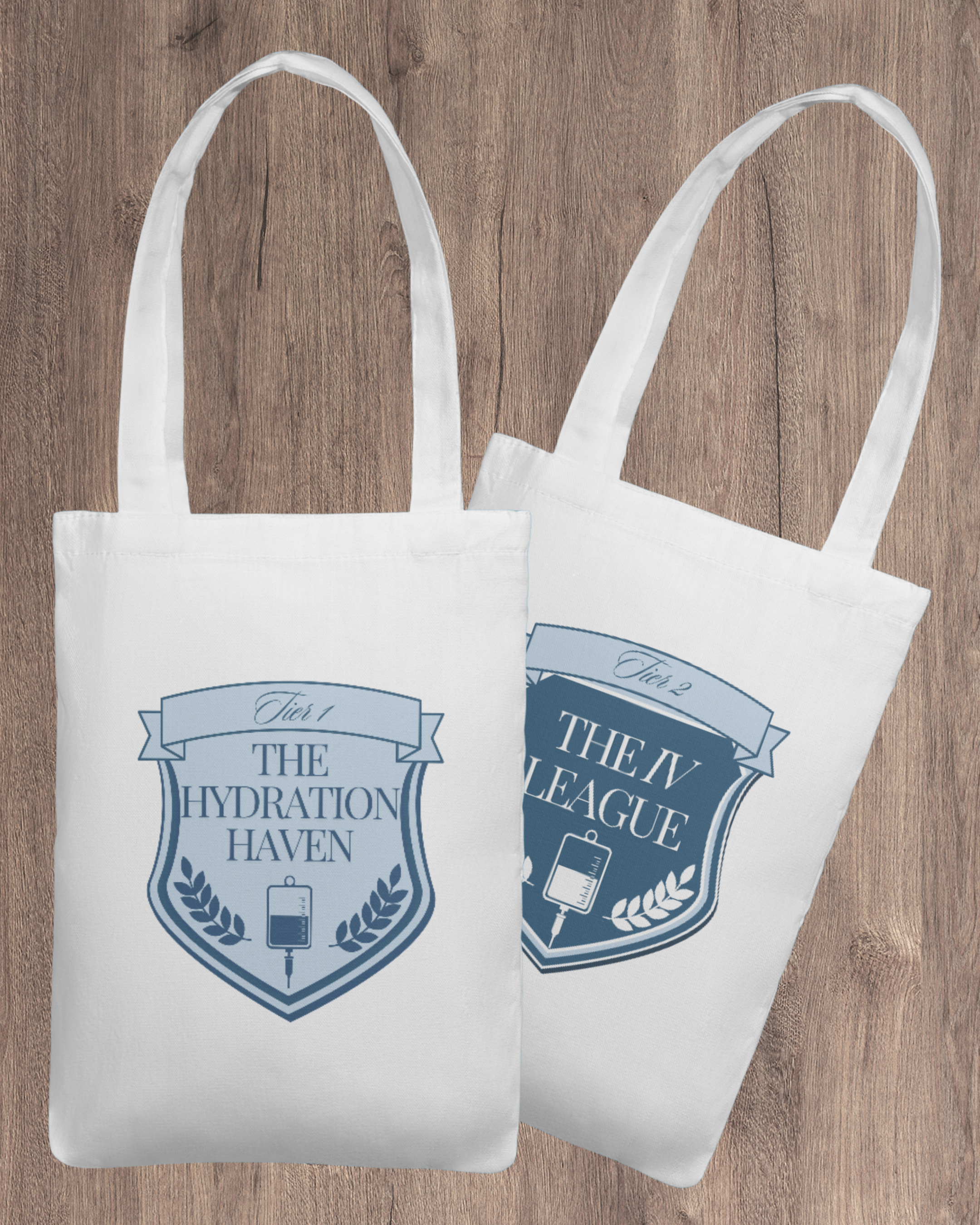 Two white tote bags with blue shield logos and text, resting on a wooden surface.