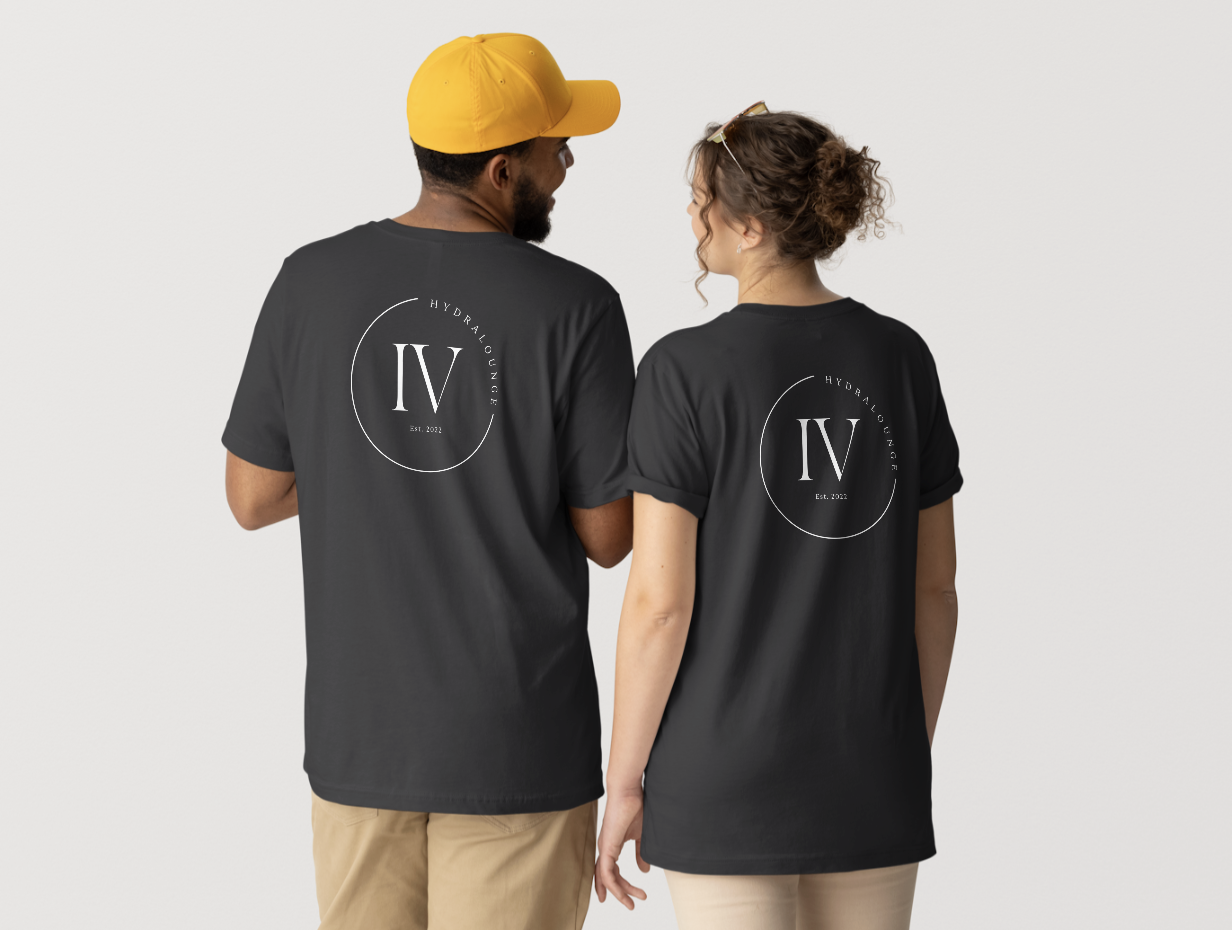 Two people, a man with a yellow cap and a woman with curly hair, wearing matching black T-shirts with a logo that reads 'IV Hydraulics' and 'Est. 2022,' facing each other against a plain background.