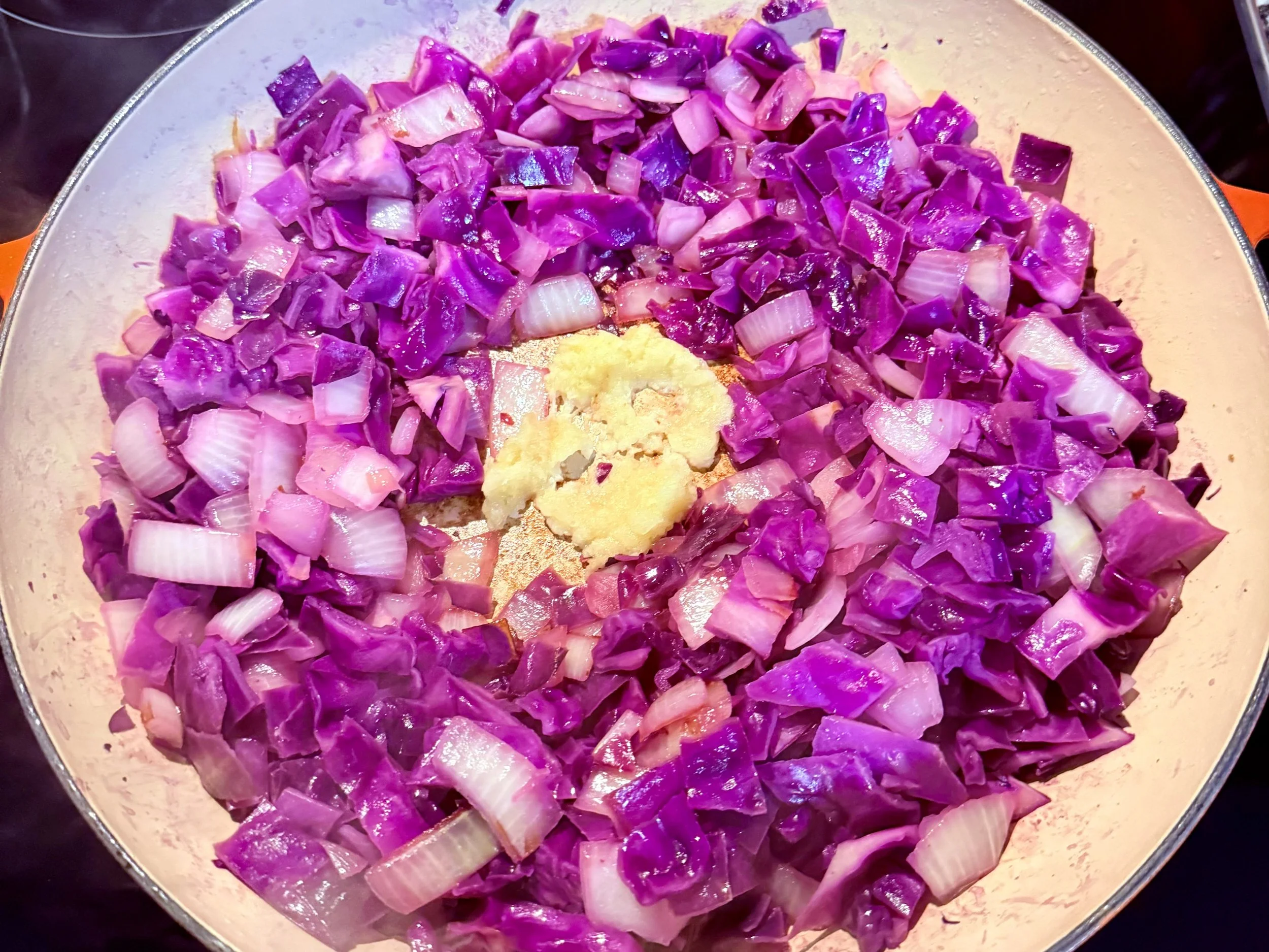 Add garlic to the sautéed cabbage mixture.
