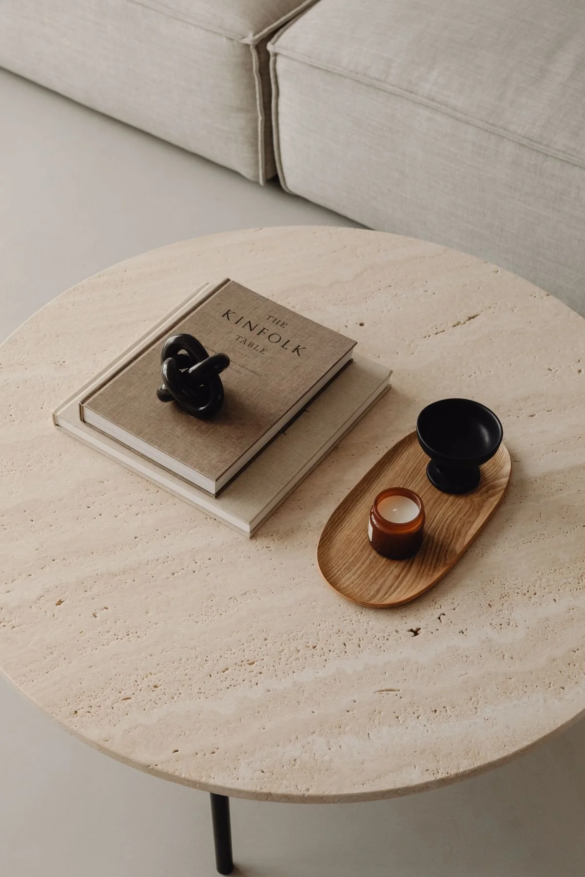 Custom Squarespace Template, E-commerce Squarespace Template, Avelã Creative. Minimalist coffee table with books, decorative knot, tray with candle and bowl, beige sofa