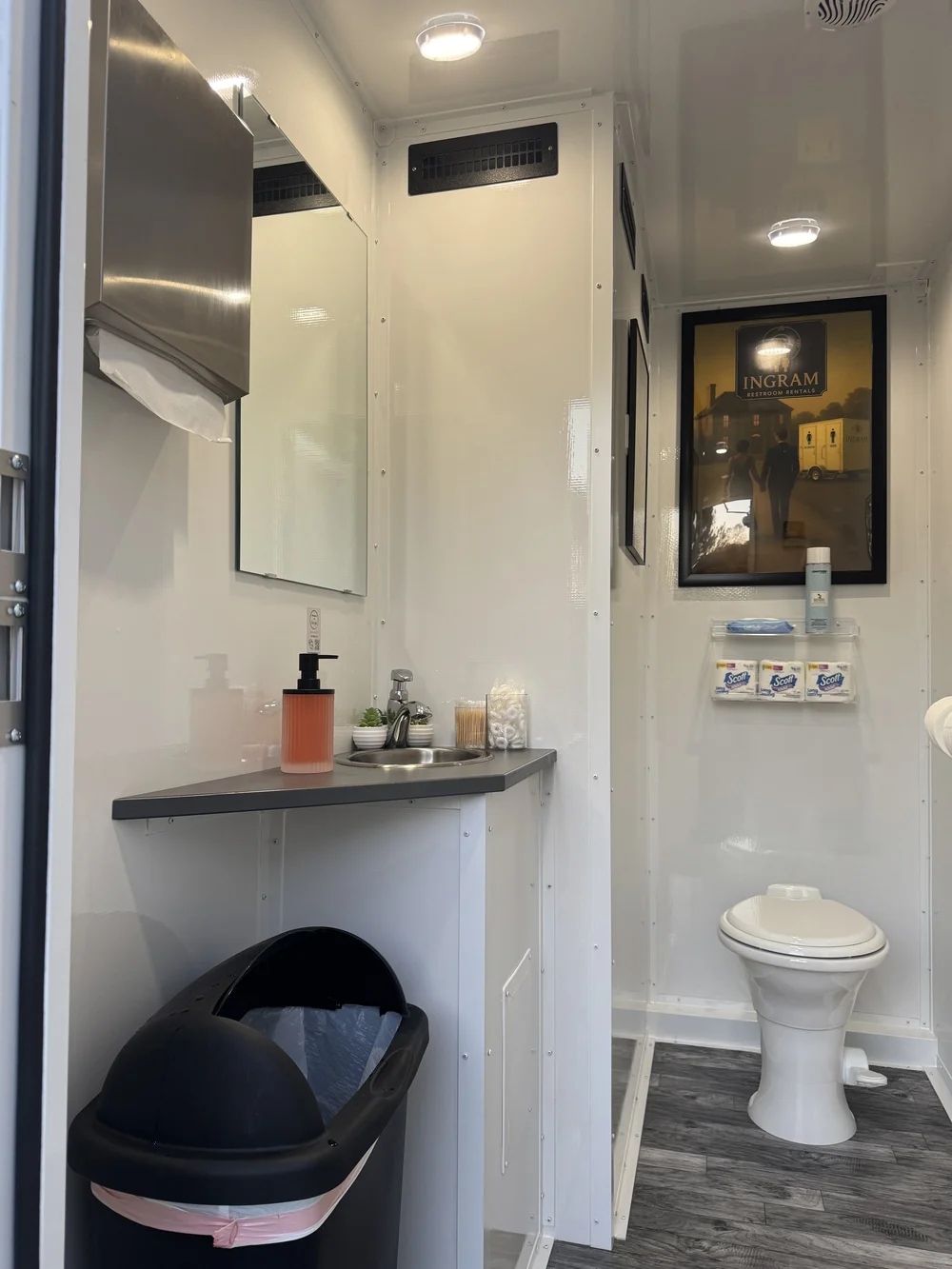 Men's side of a luxury restroom trailer with running-water sink