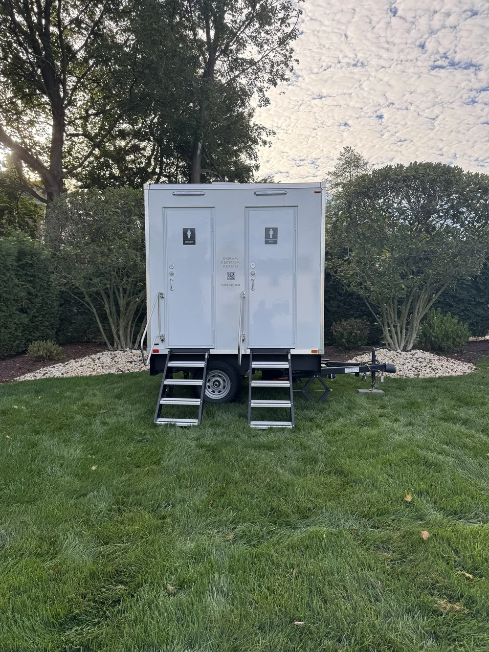 An Ingram restroom trailer set up on a lawn