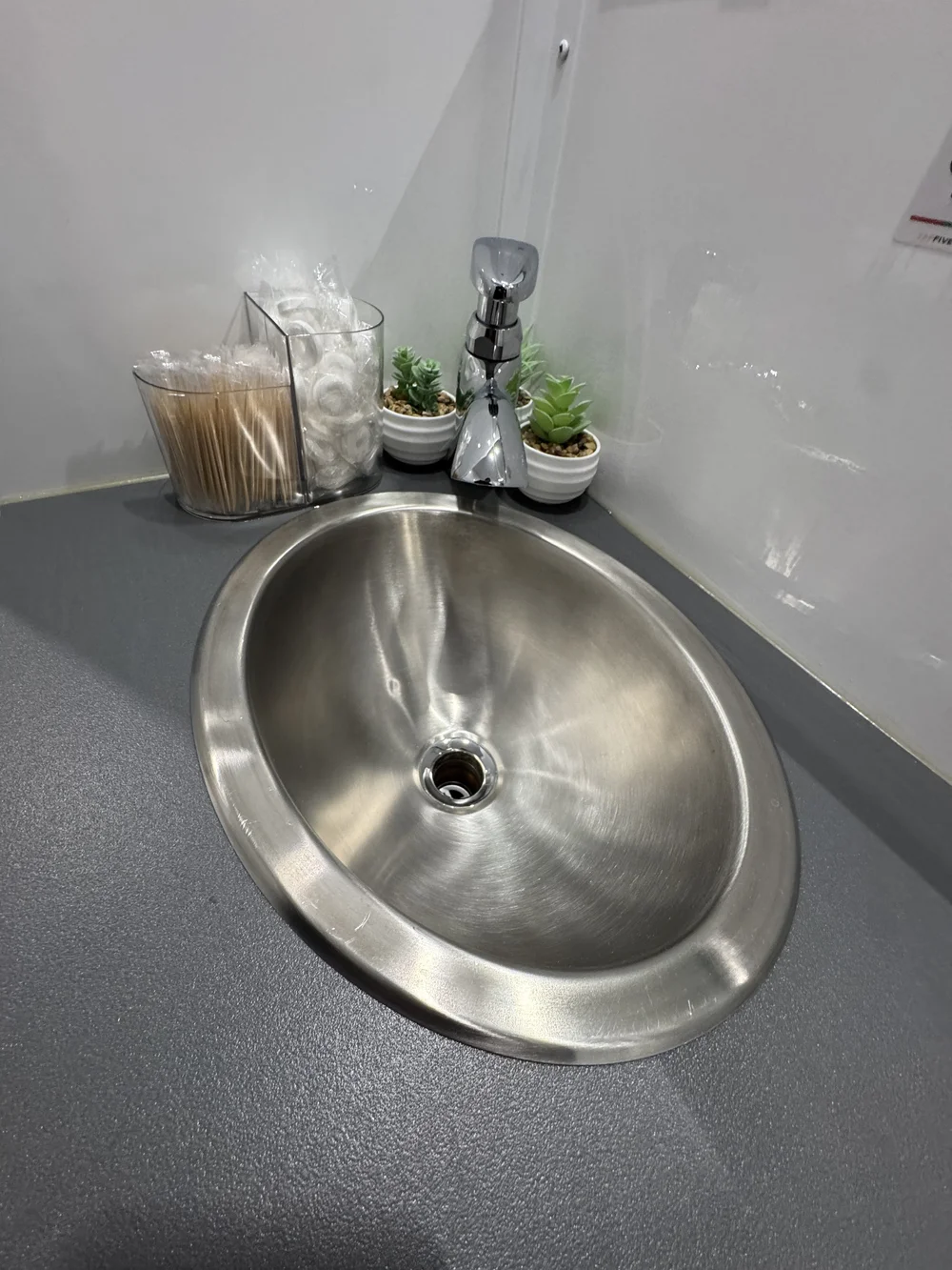 Stainless steel sink with running water and hand soap