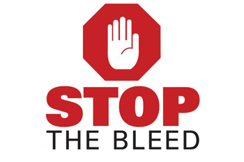 Red stop sign with a white hand symbol and the words "STOP THE BLEED" beneath it.