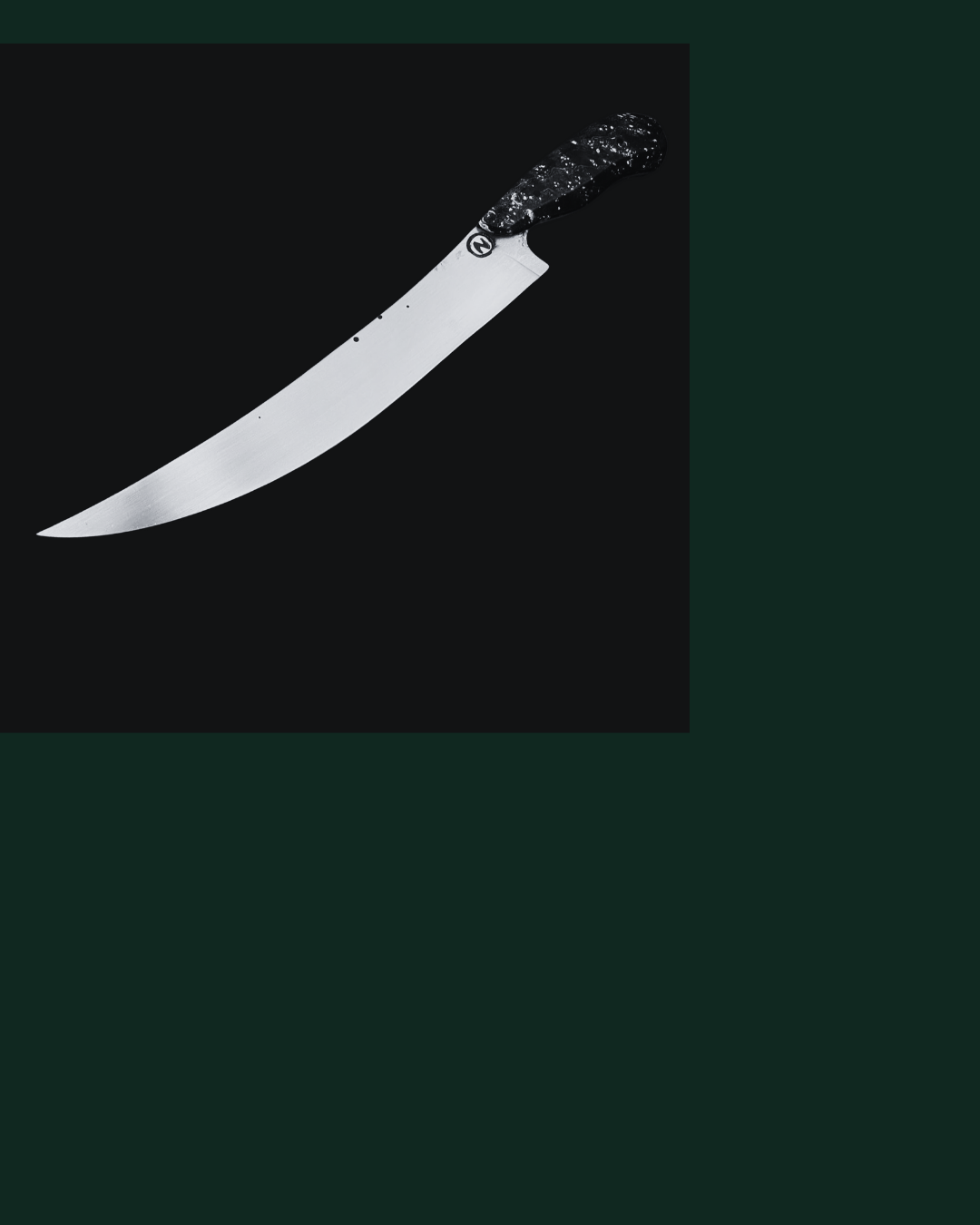 A curved kitchen or hunting knife with a black and white marbled handle on a dark background.
