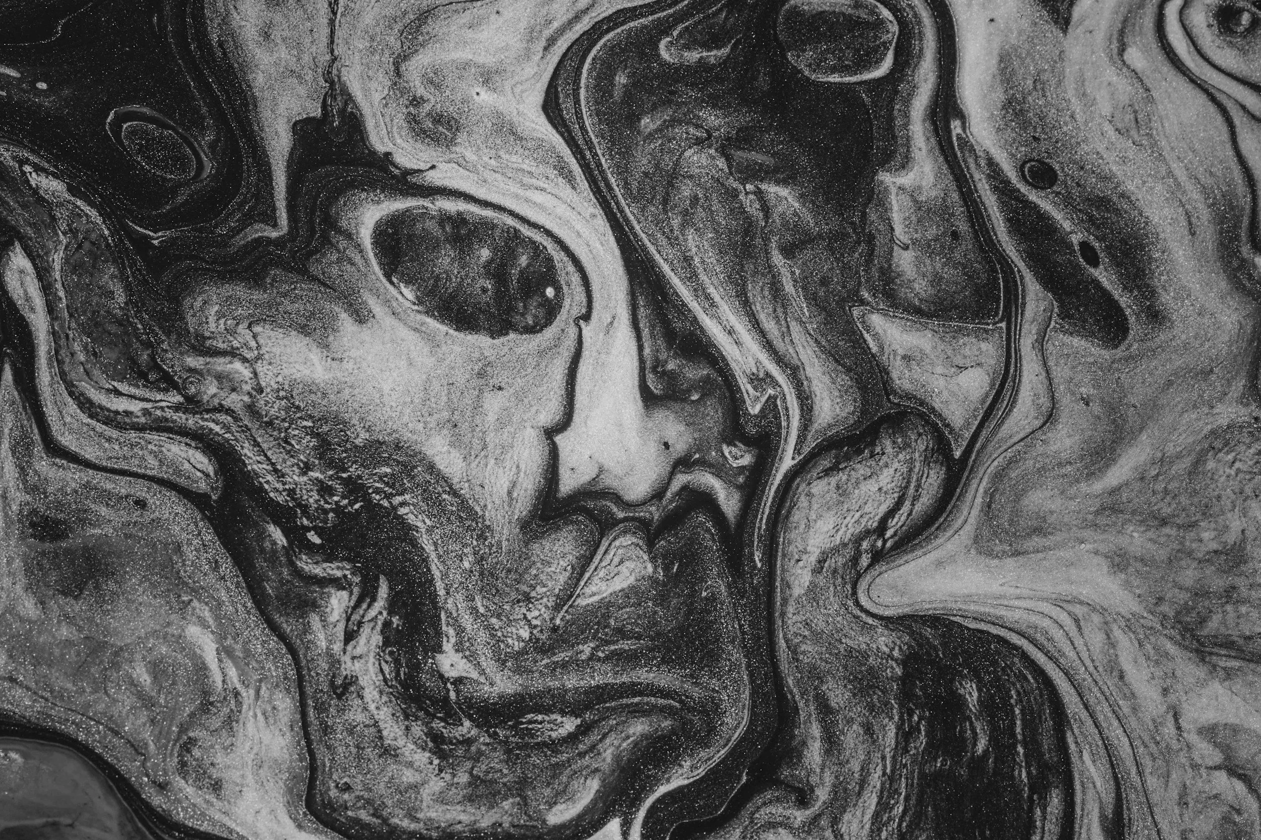 Black and white abstract art resembling a woman's face with flowing hair.