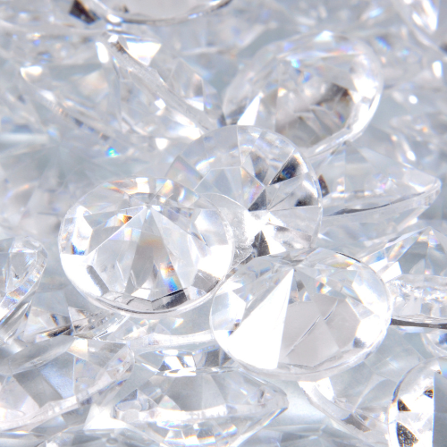 Close-up of clear, faceted acrylic or glass gemstones or crystals.