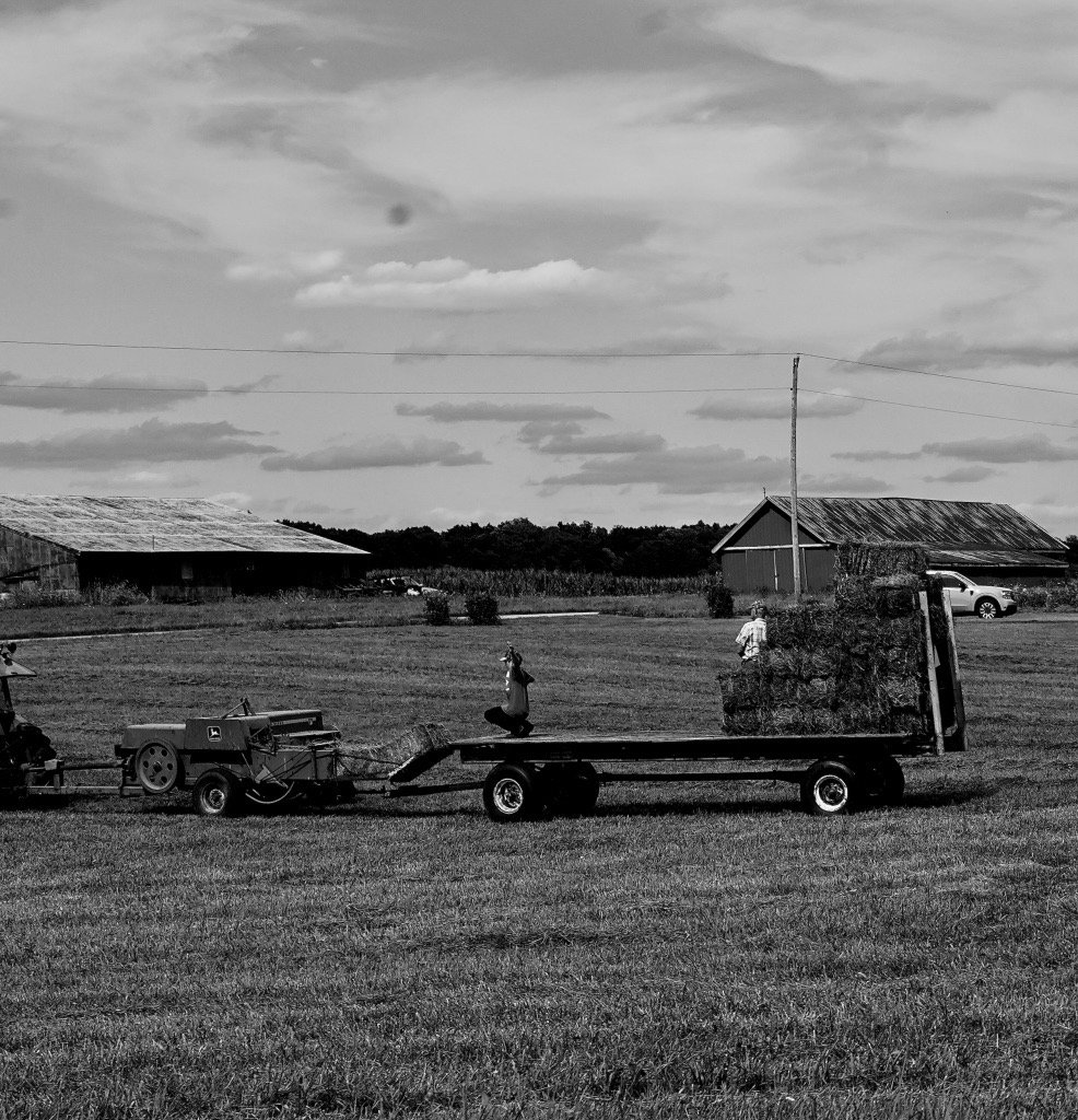 Grandfather and Grandson bail together on family farm. 2024. Wabash, Indiana. 