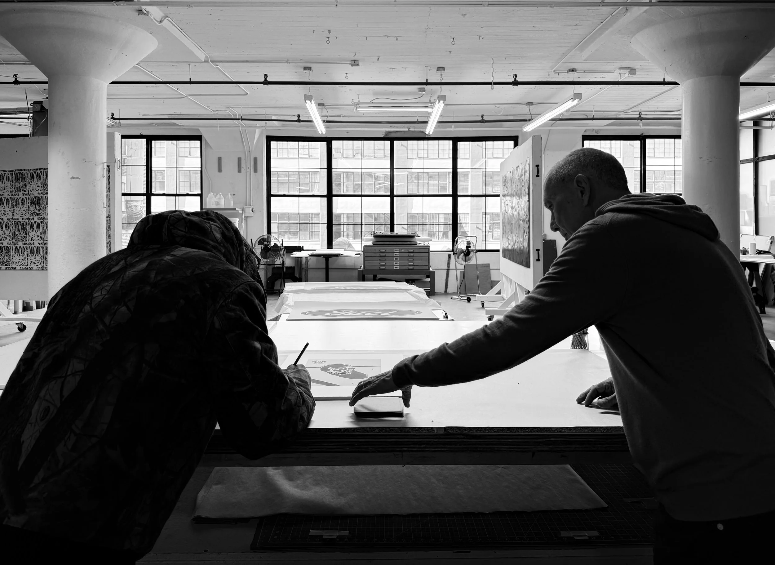 Erik Brunetti and Robert Blanton reviewing and signing edition impressions at Brand X Editions, New York, 2025.
