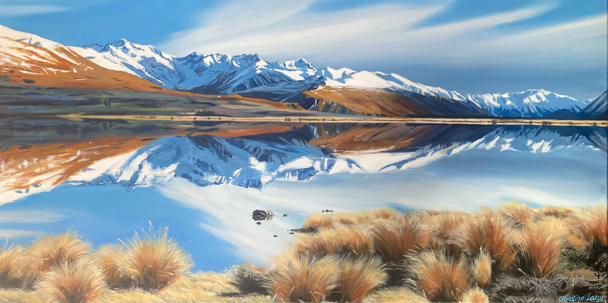 A scenic landscape painting of snow-capped mountains reflected in a calm lake, with grassy foreground and a clear blue sky.