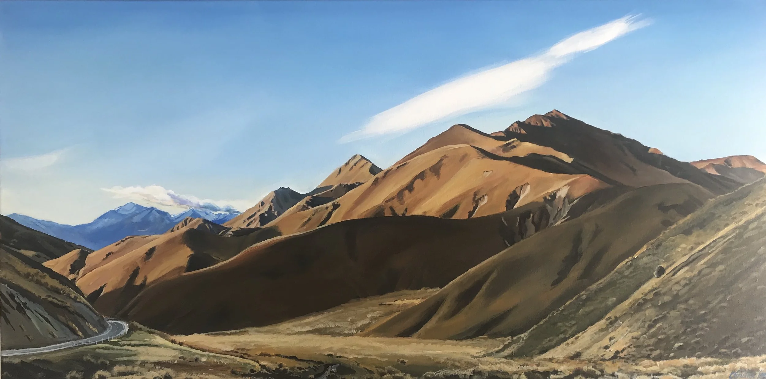 A landscape painting of mountain ranges with brown, tan, and dark green slopes, a winding road in the foreground, and a clear blue sky with a few clouds in the background.