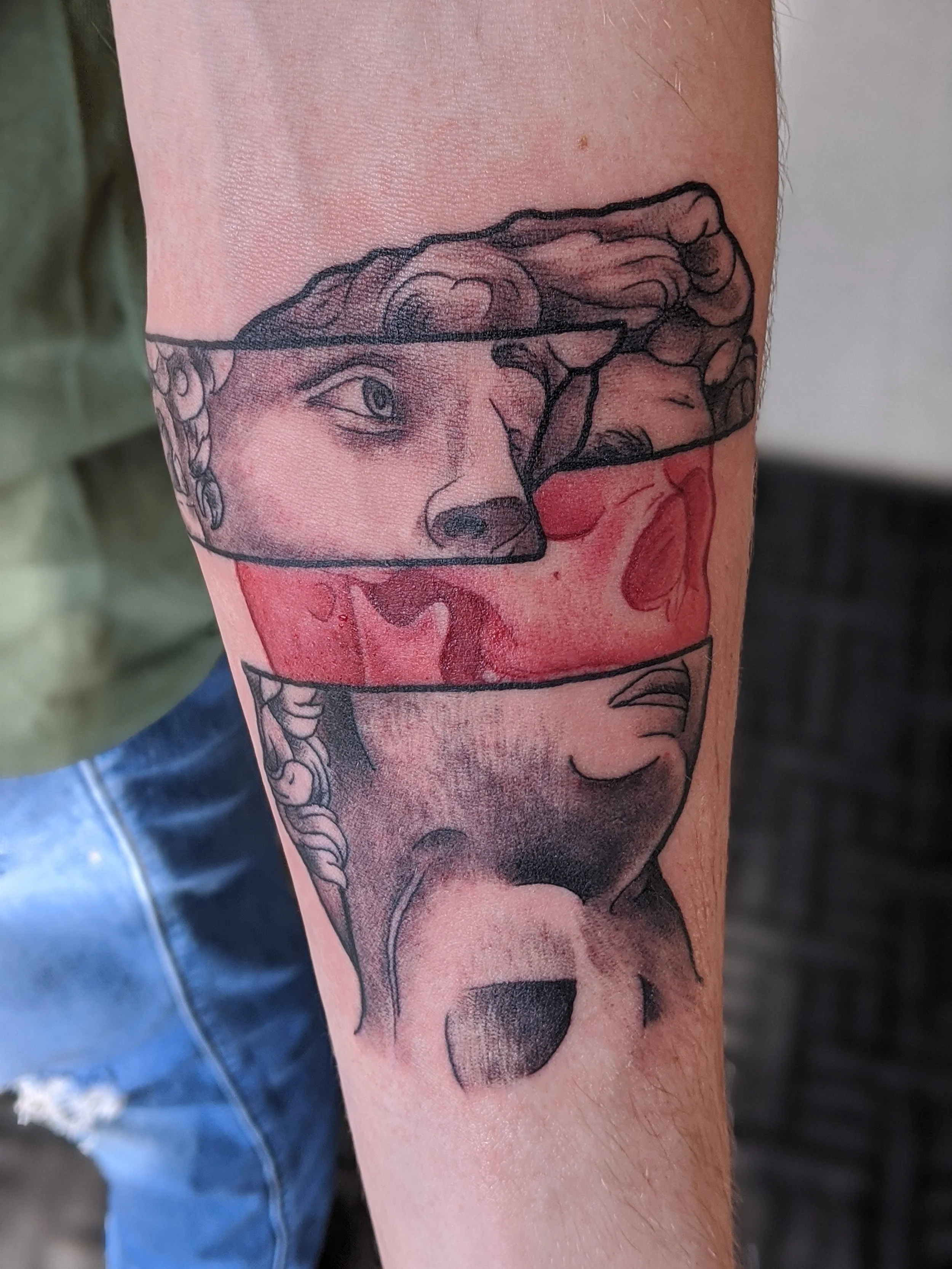 Tattoo depicting a woman with braided hair, with her face partly covered by a hand and red smoke or ink surrounding her face.