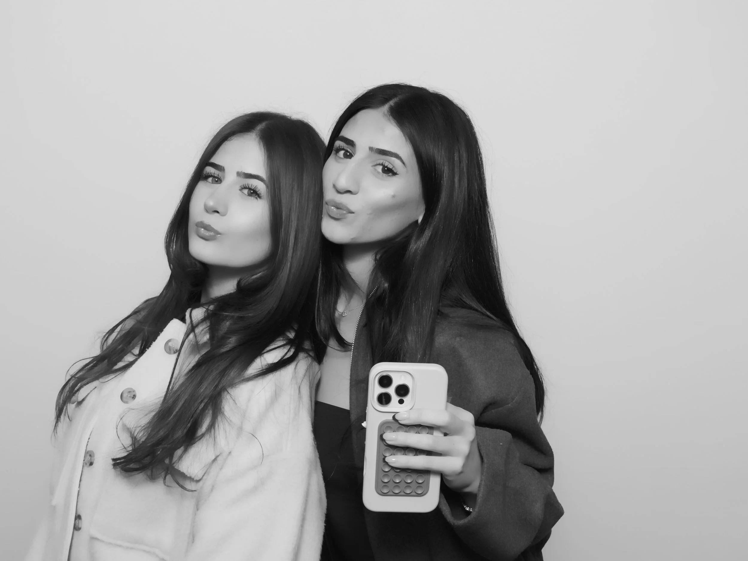 Guests posing inside a magazine style photo booth in Los Angeles