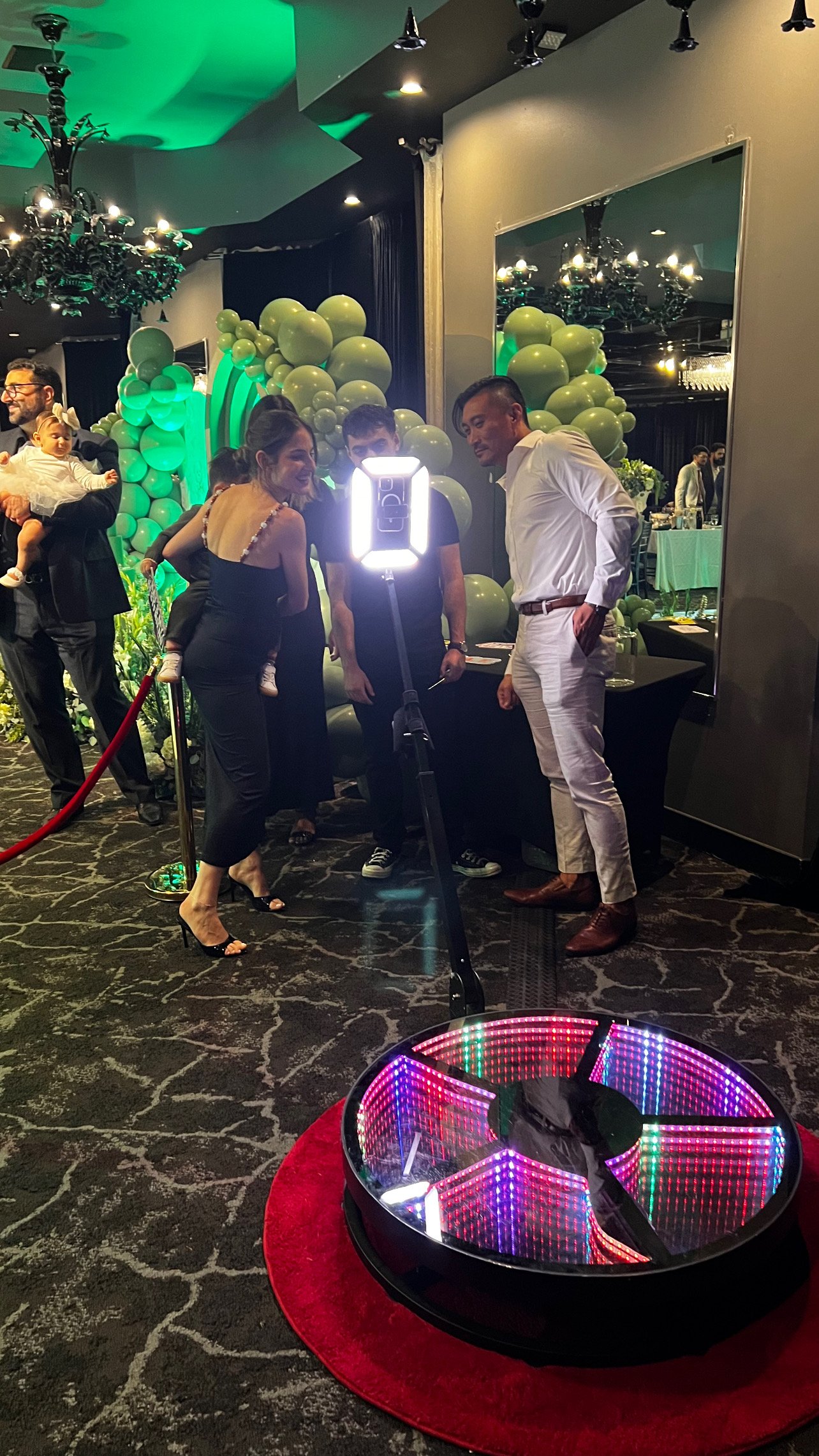 People playing the game Chat Shot at an event, with balloons and decorations in the background.