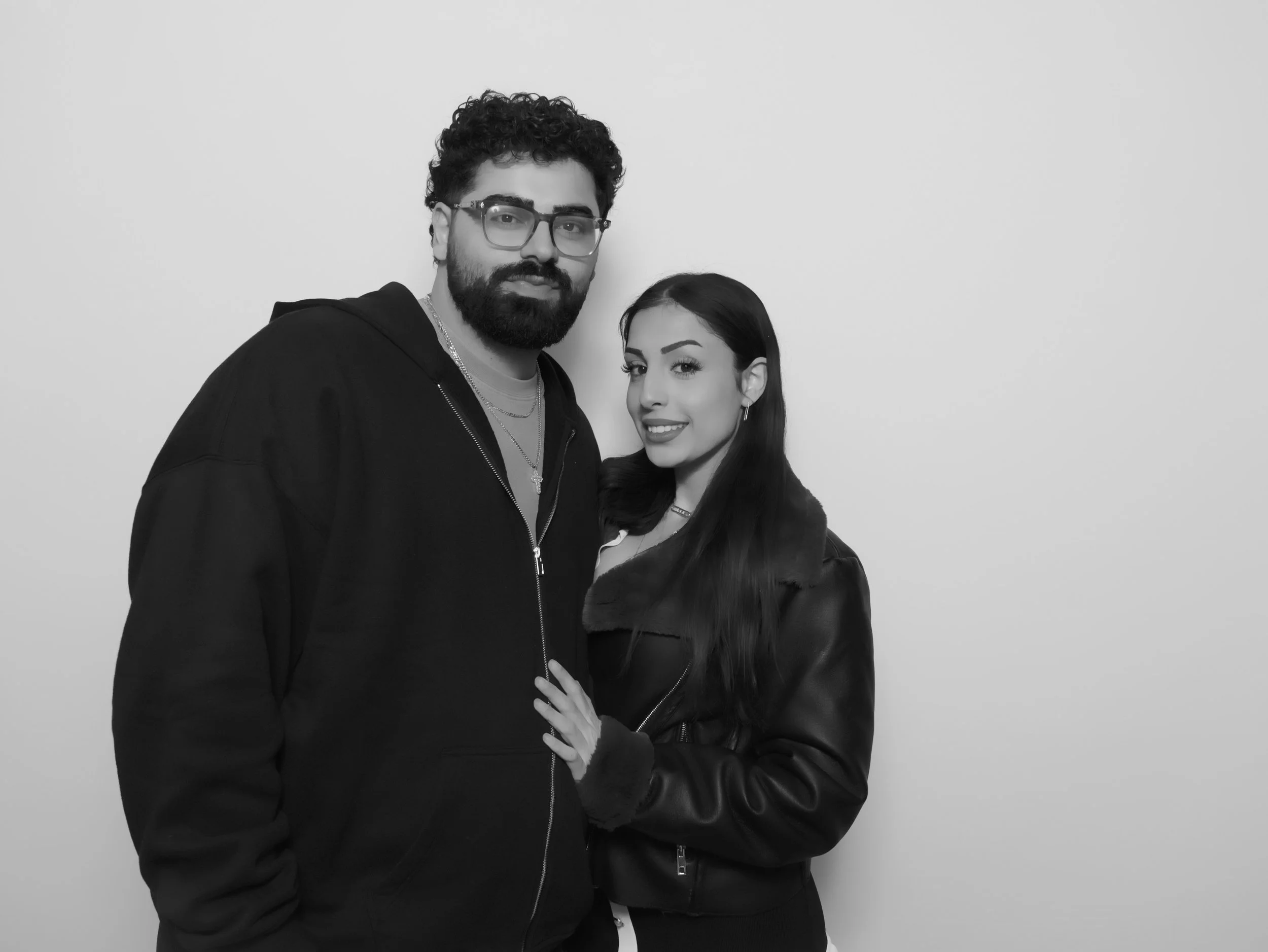 Guests on a glass 360 video booth platform with LED lighting in Los Angeles