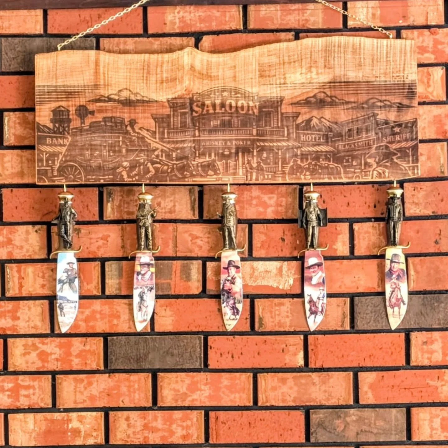 The Western scene hung up over the clients fireplace sporting those John Wayne collectors knives. Loving how this piece came together with the brass hardware.