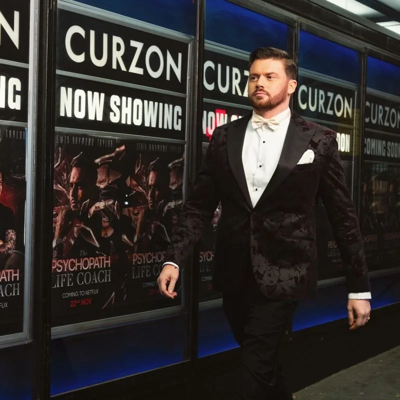 Lewis Raymond Taylor, of The Psychopath Life Coach fame, walking down the Netflix red carpet for his Documentary.