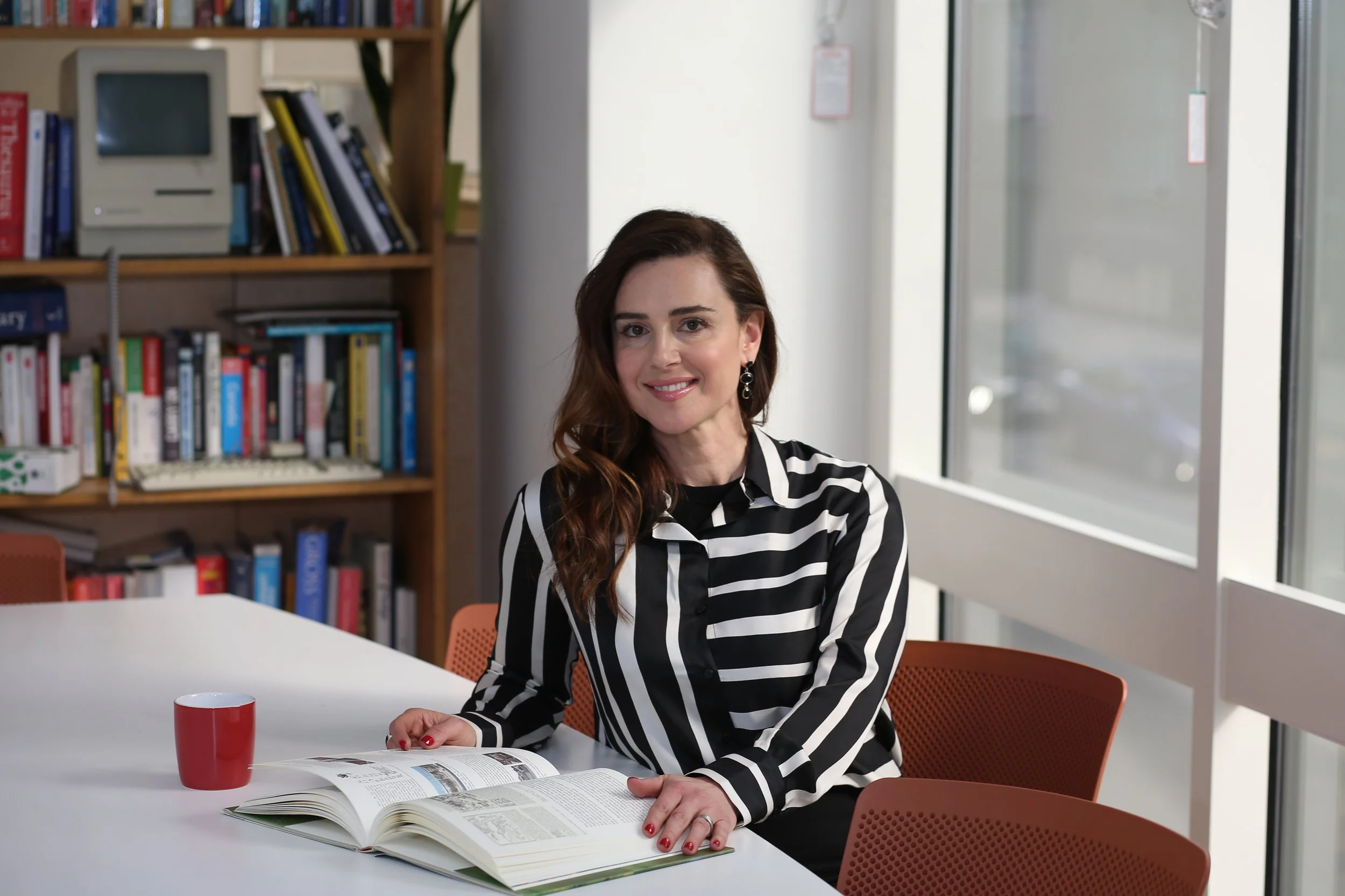 Alexandra King, podcast host and entrepreneur of BBC'S The Apprentice fame, sitting and reading a book