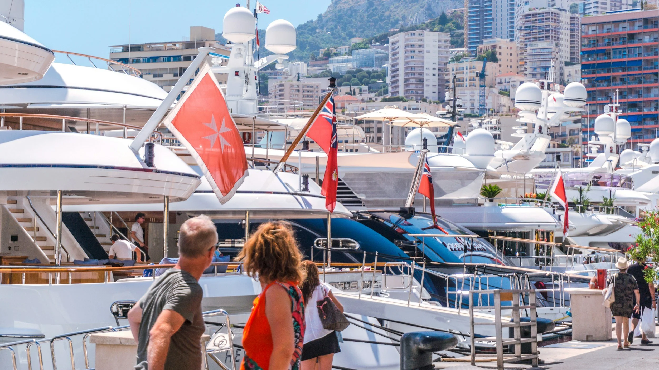 Superyachts flying the Red Ensign moored stern-to in a Mediterranean harbour