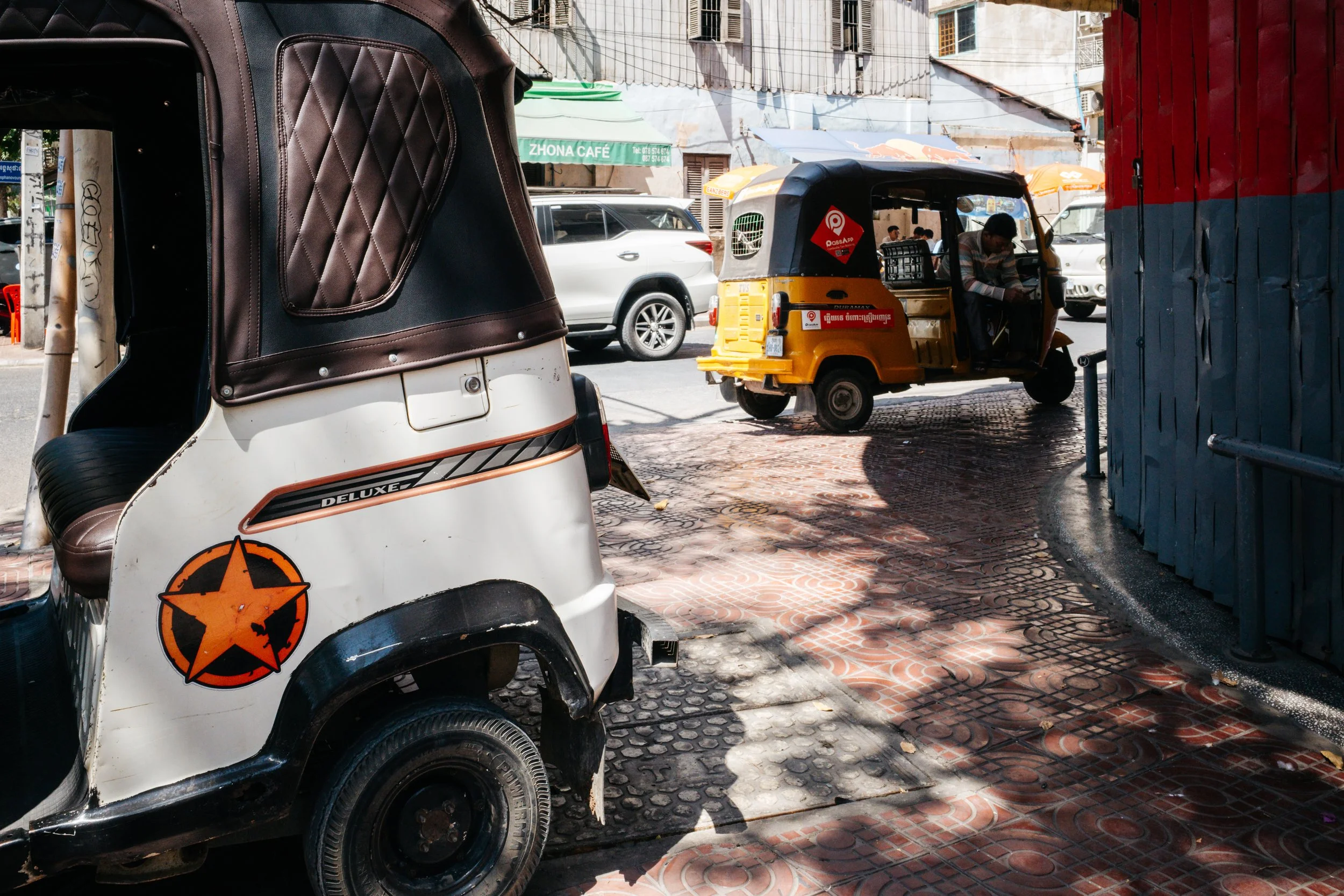 Two Tuktuks and a car
