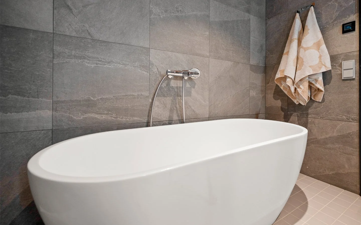 Kylpyhuoneen sisustussuunnittelu, jossa sisustusarkkitehti ja suunnittelutoimisto Veemin yrittäjä on suunnitellut 70-luvun omakotitaloon Spa osaston Laattapisteen laatoilla.