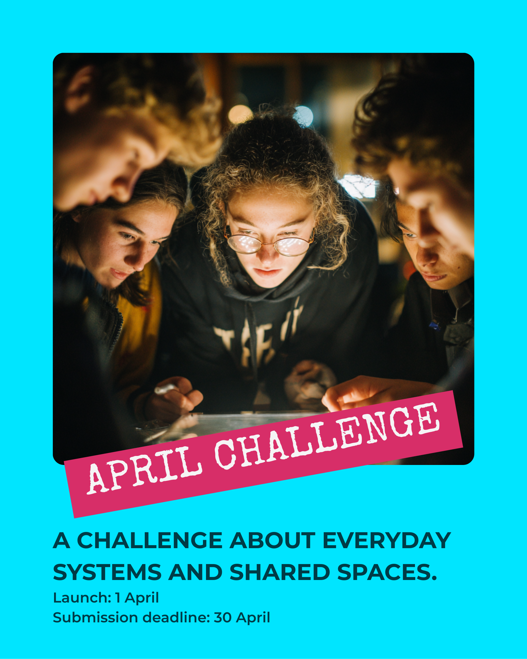 Group of young people closely gathered looking at a screen during April challenge event.