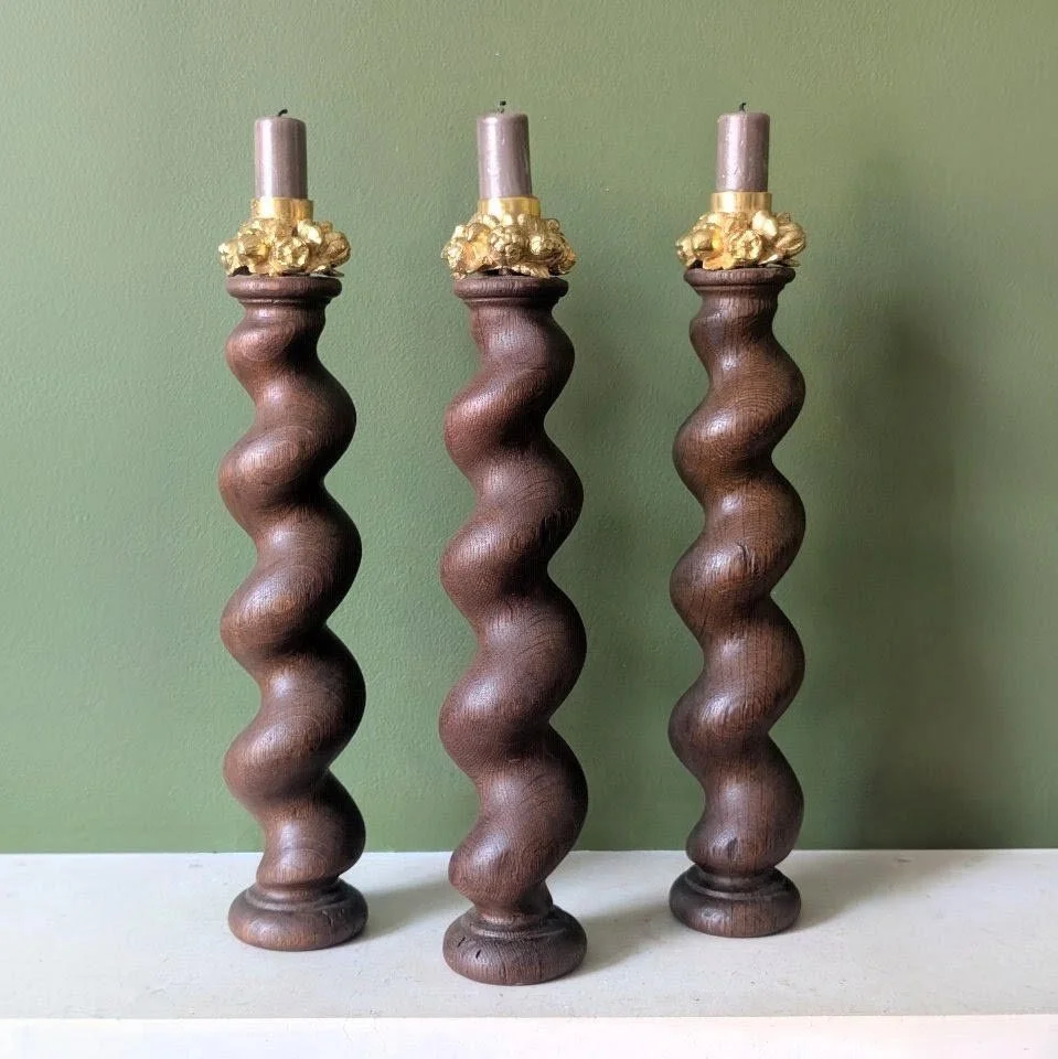 A set of three oak candlesticks