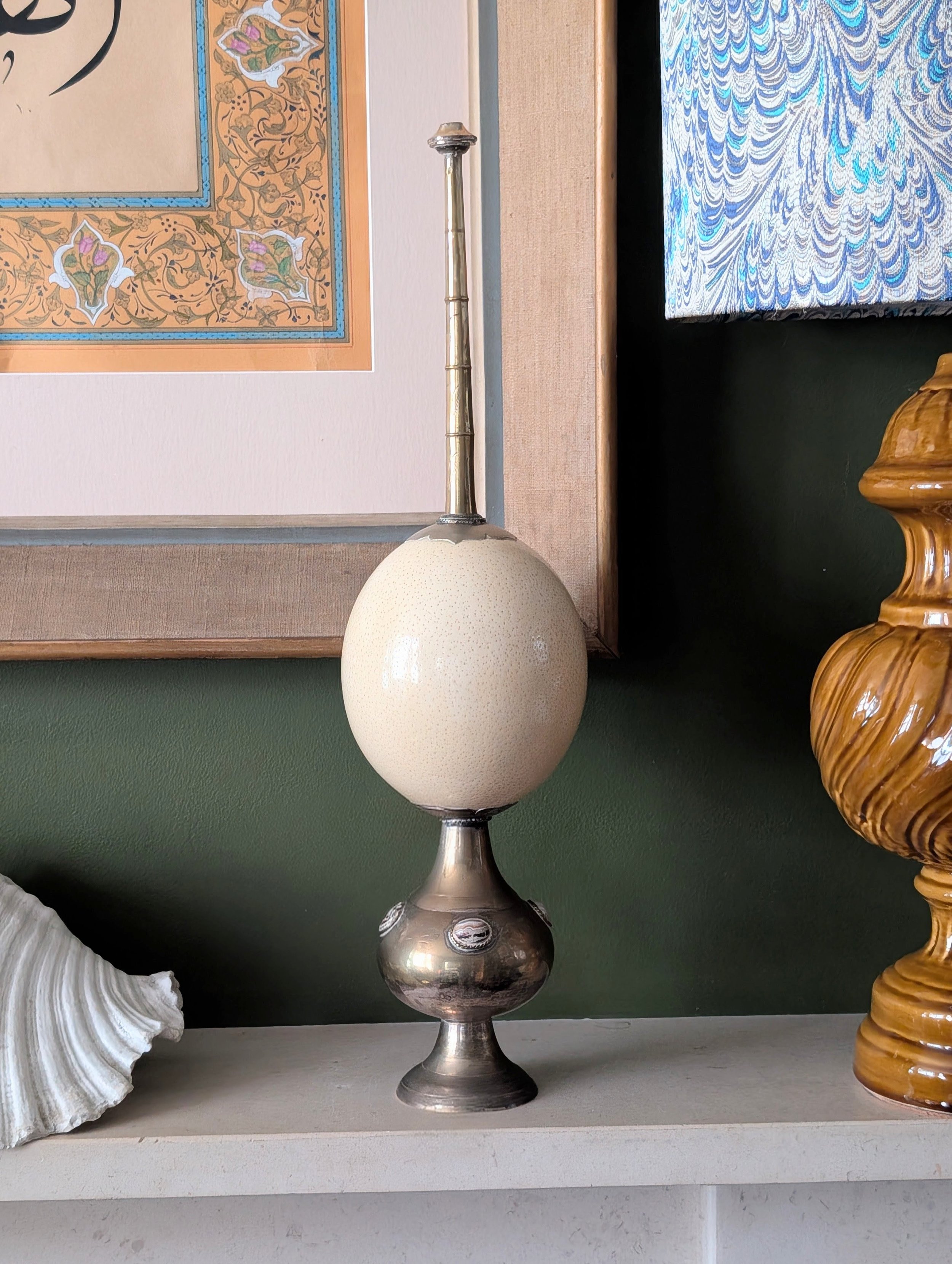 A brass-mounted ostrich egg candlestick by Anthony Redmile