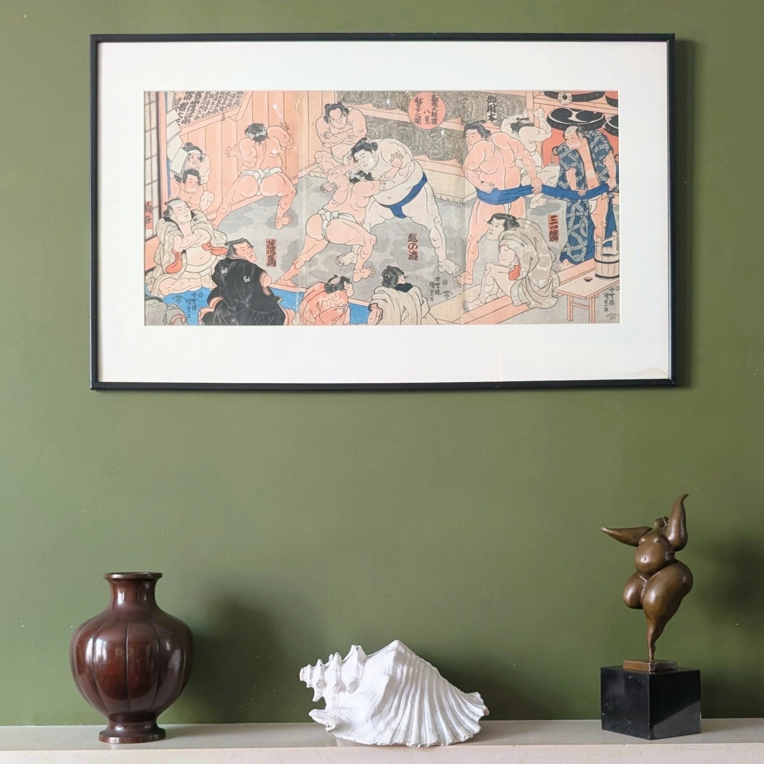 A woodblock print triptych of Sumo practice