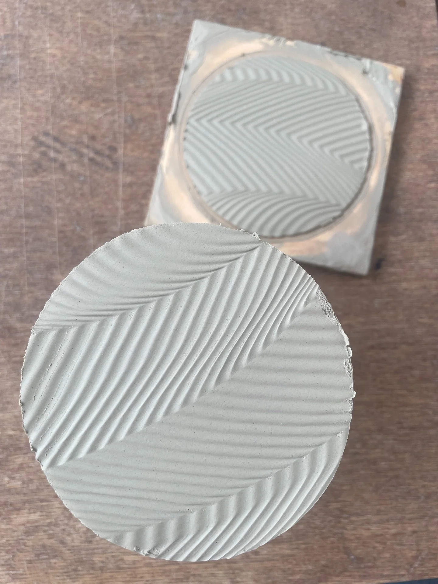 Fun base on a mug that I made yesterday, not quite ready to trim but I could turn them over, then some test tiles came out of Amy&rsquo;s gas kiln which was exciting. I was testing to see how well three different inlayed slips showed through my green