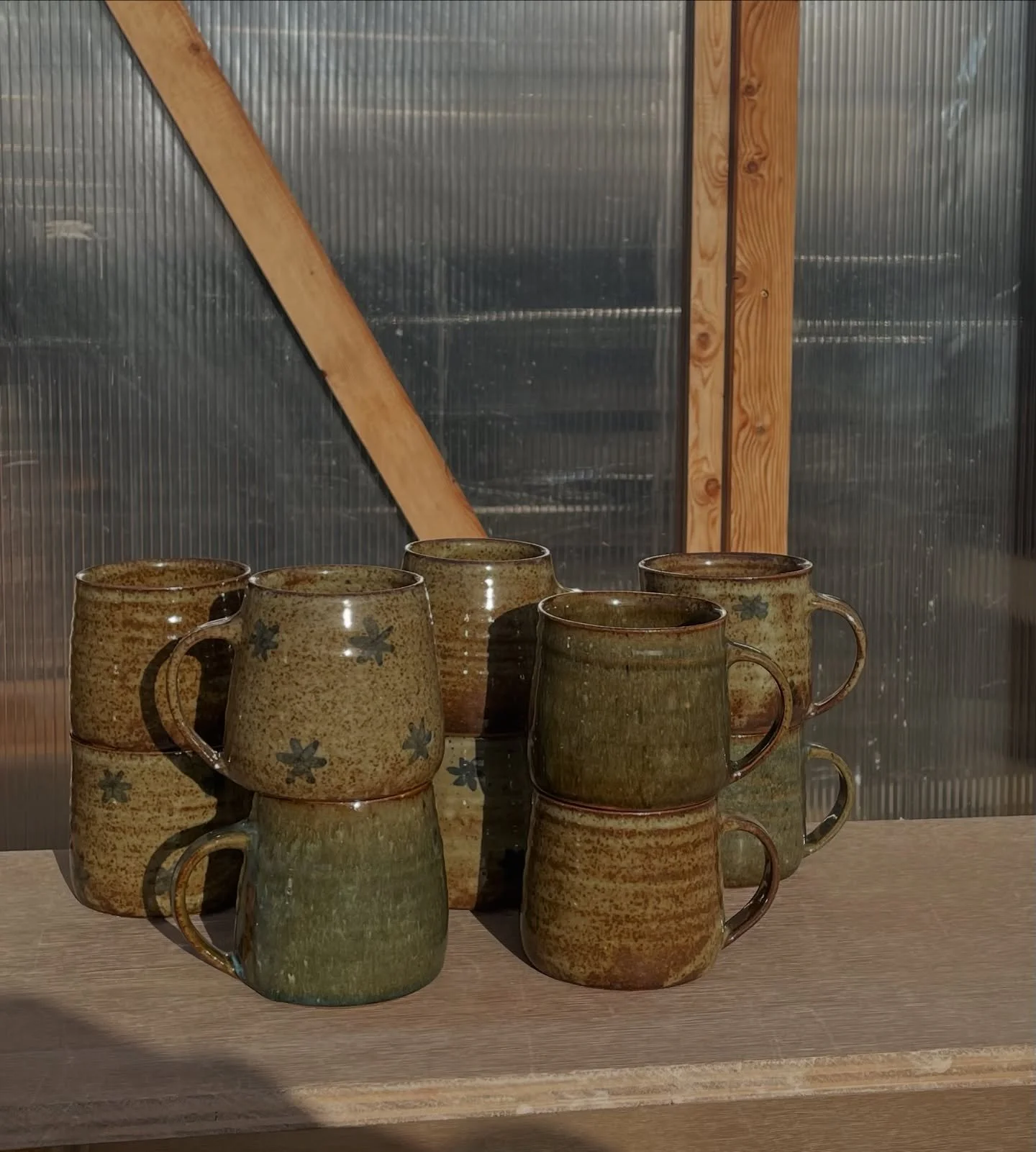 Gas kiln mugs in two distinct shapes 
Half are fairly straight sided with a slight flair at the top and the other half taper in both with visible throwing lines which let that glaze pool and break nicely :) 
Luckily the sun came out today to get some