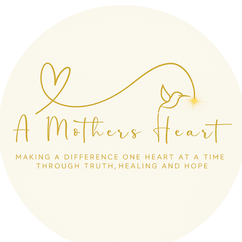 A logo for "A Mothers Heart" featuring a simple gold-colored line drawing of a hummingbird with a heart-shaped flight path, accompanied by text that reads "Making a difference one heart at a time through truth, healing, and hope."