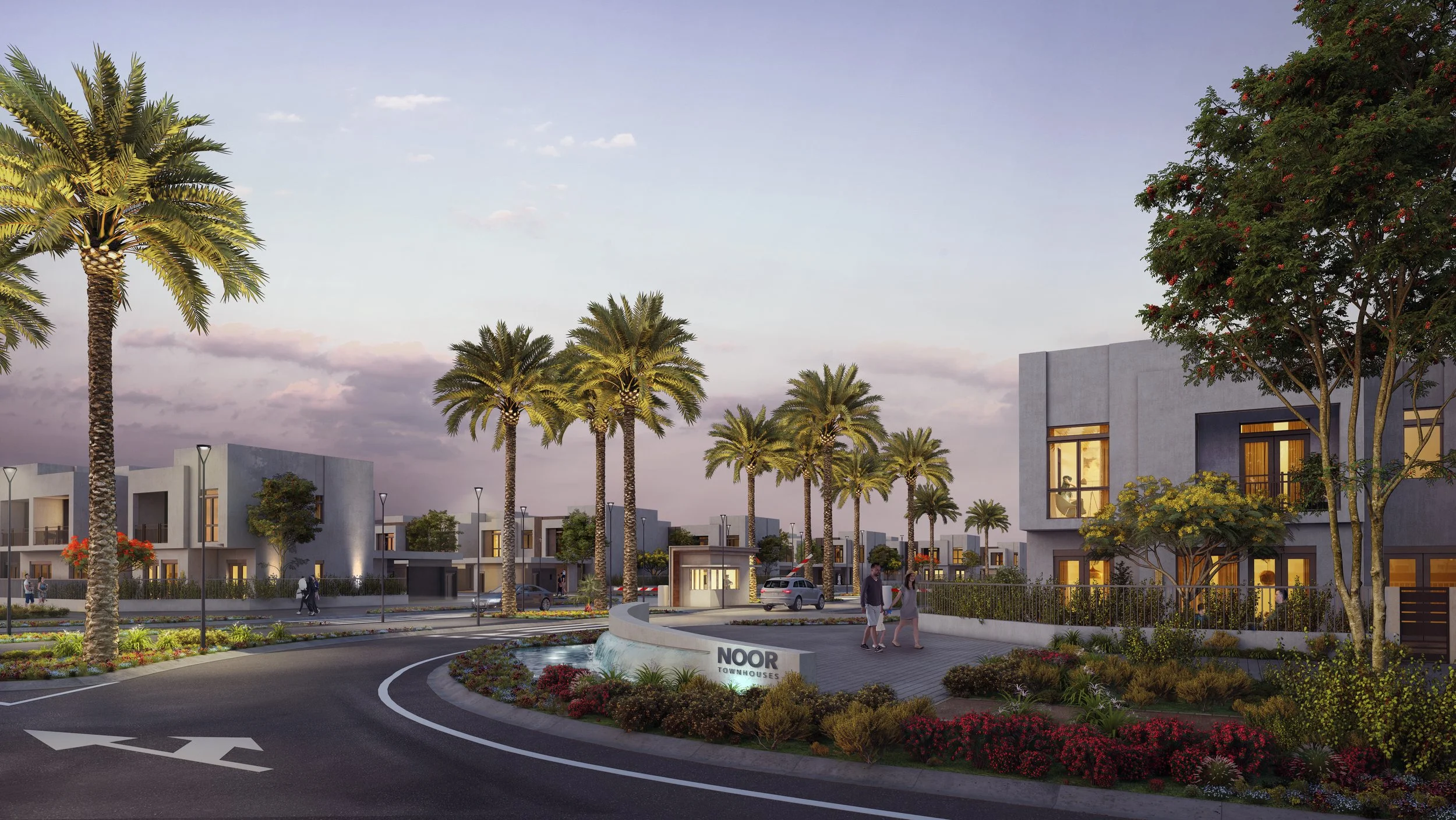 A modern residential community with townhouses, palm trees, and landscaped gardens at sunset. People walk along the sidewalk near a sign that reads 'NOOR TOWNHOUSES'.