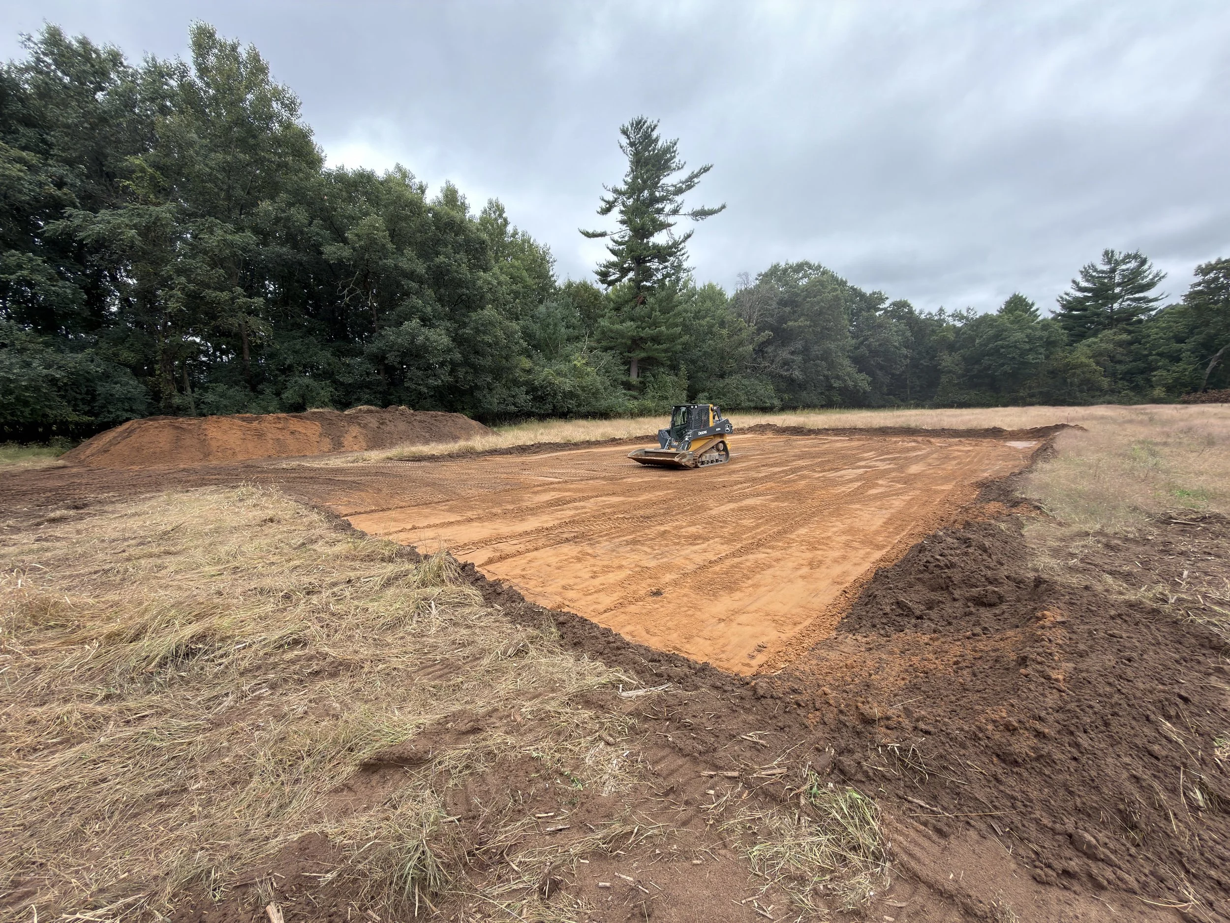 Earth moving equipment in a hole it dug