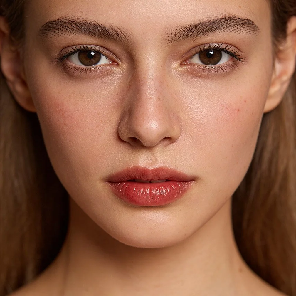 Close-up of a woman's face with brown eyes, light skin, and natural makeup.
