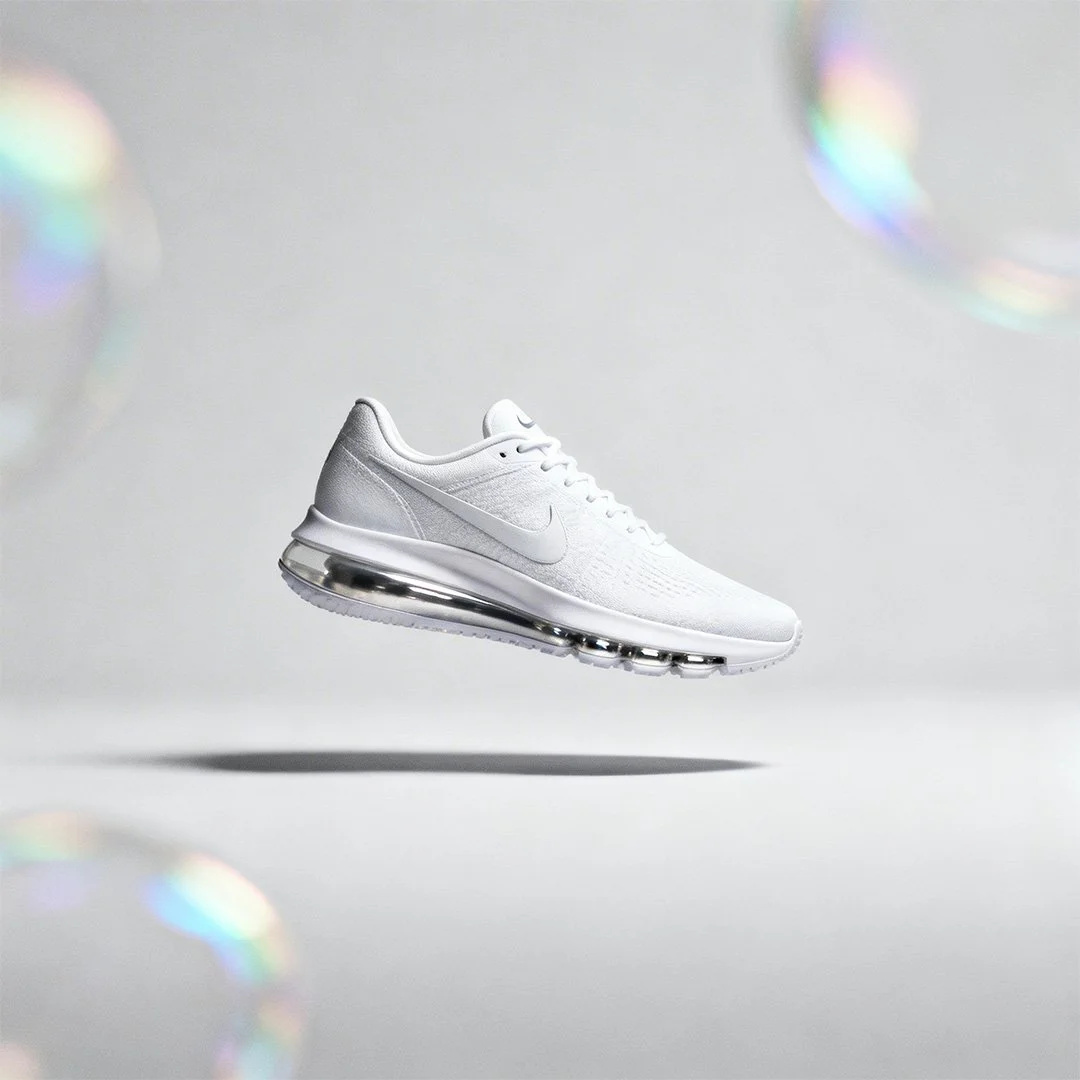 freepik_editorial-fashion-nike-ad-model-wearing-minimal-white-sneaker-abstract-light-grey-background-subtle-soft-rainbow-oil-shimmers_0001.jpg