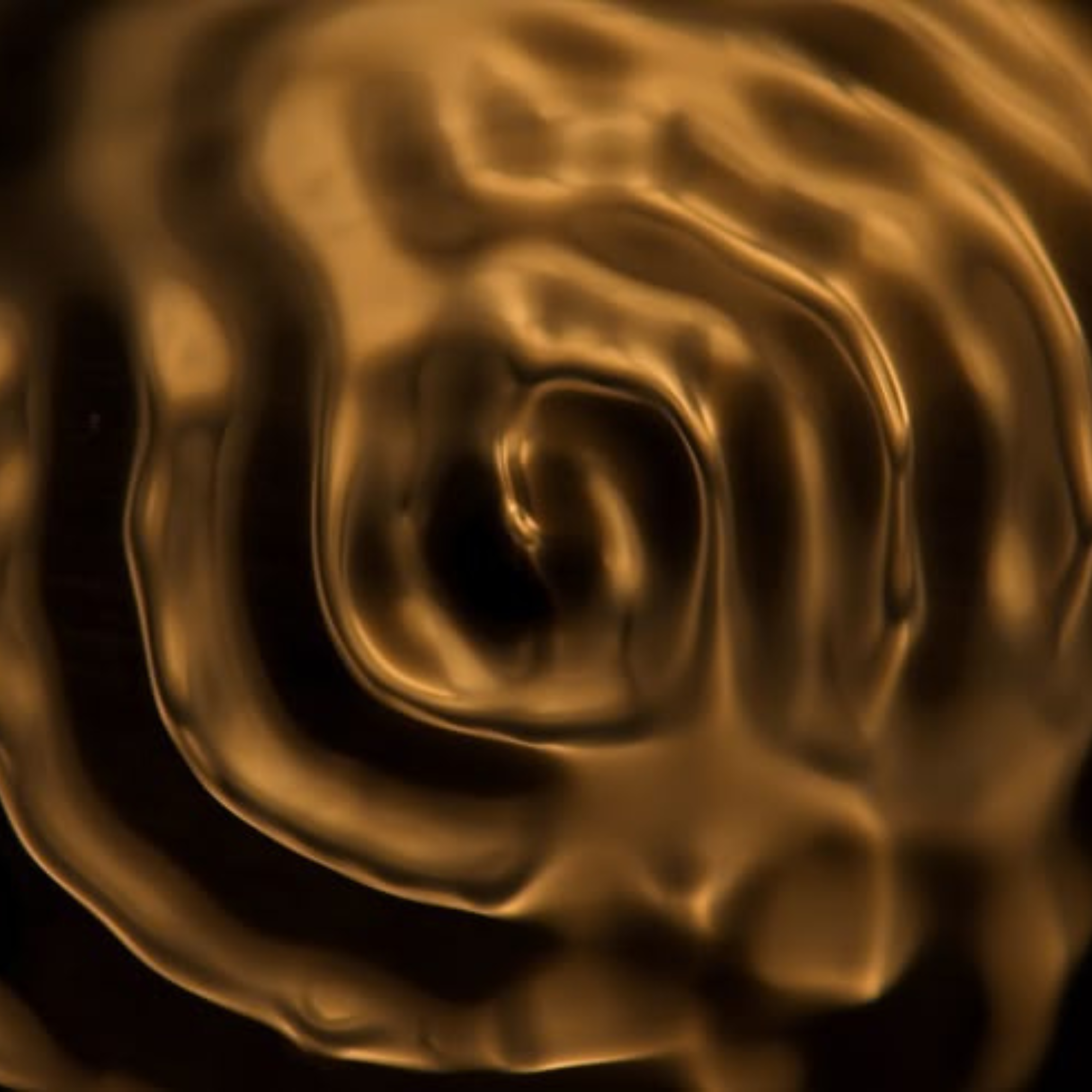 Nahaufnahme von goldfarbenen, spiralförmigen Mustern mit glänzender Oberfläche.
