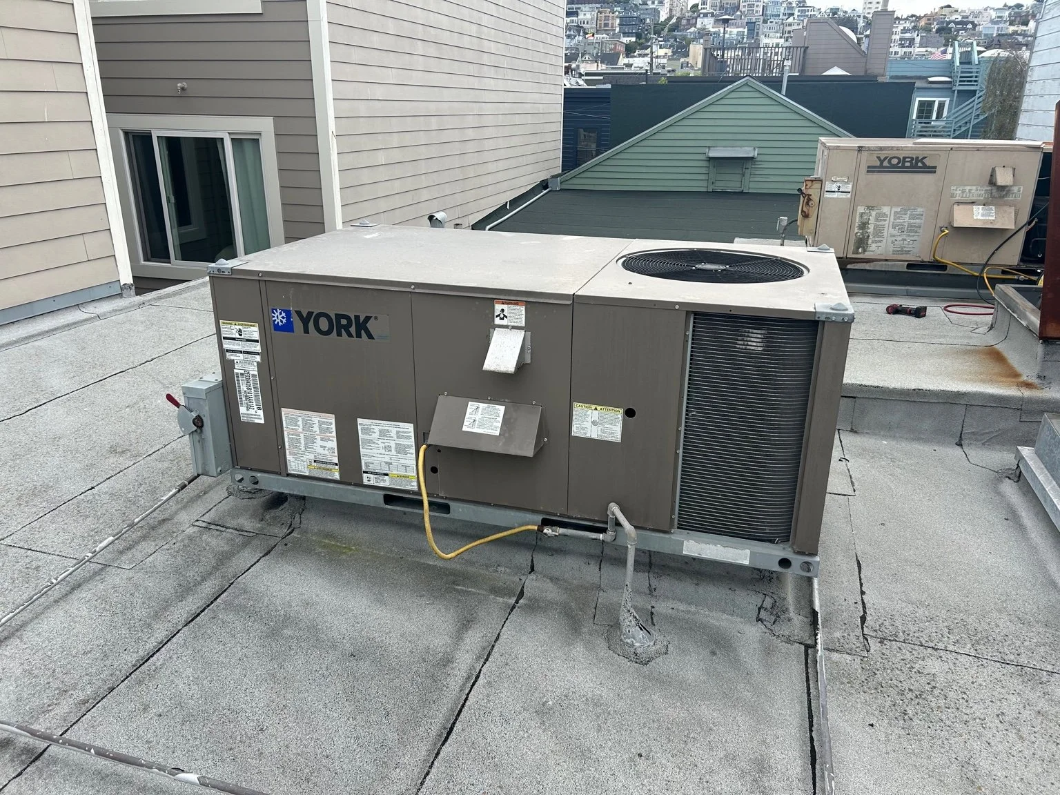 Heating system installation and maintenance — YORK gas furnace rooftop setup with safety and performance checks