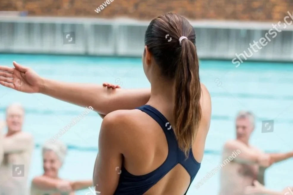 stock-photo-rear-view-female-yoga-trainer-instructing-senior-swimmers-at-poolside-644729485.jpg