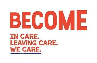 A hand placing a wooden block on an arranged tower of similar blocks on a wooden surface.