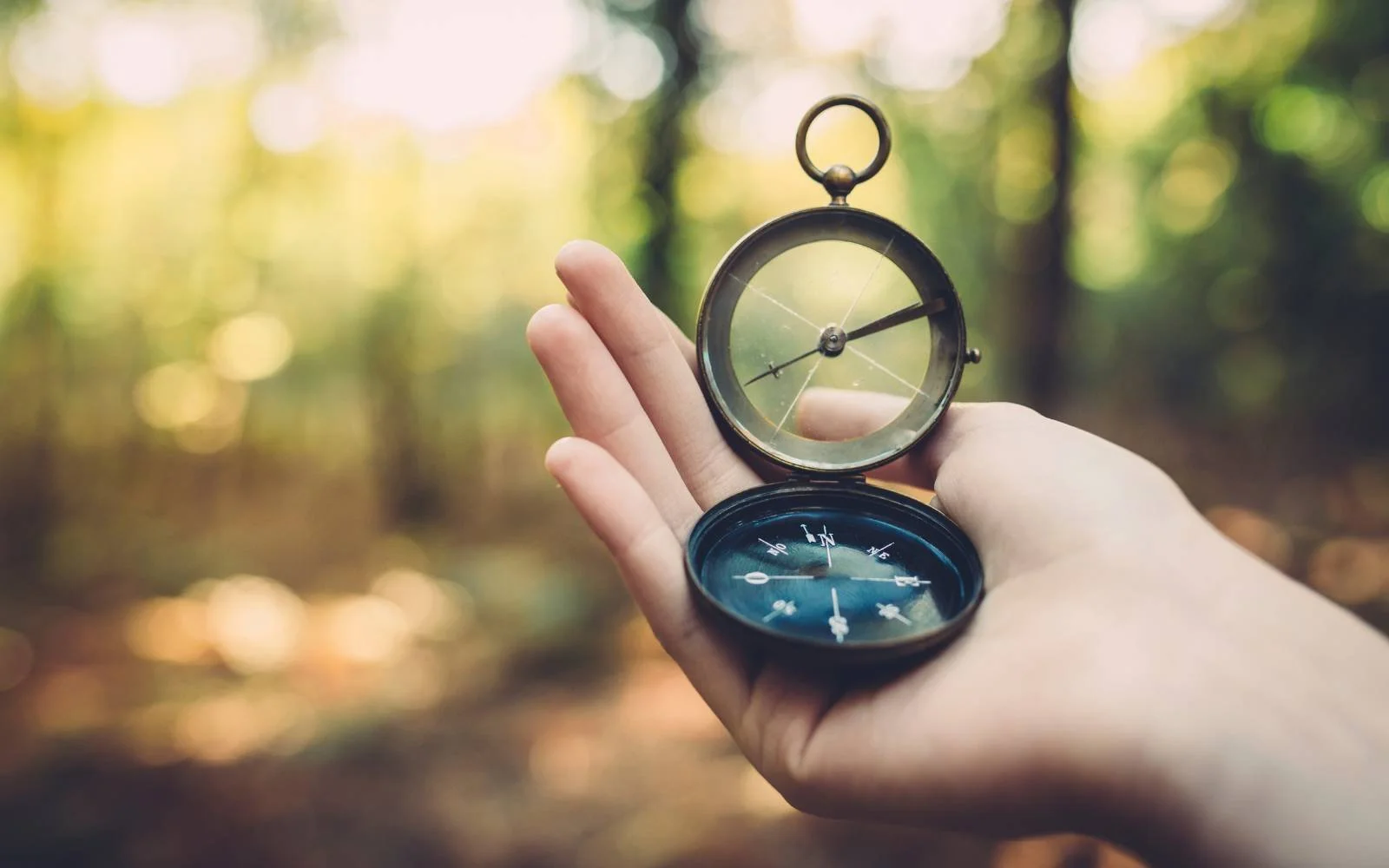 Compass in hand symbolizing leadership direction and designing leadership with greater ease.